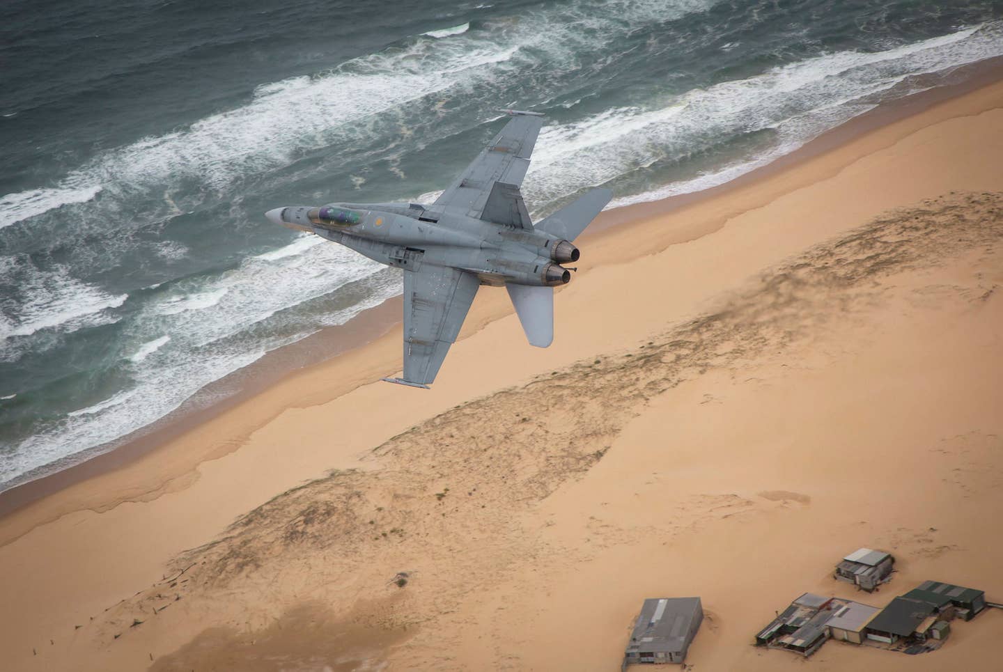 A RAAF Hornet in action low over the coast during its time in service. (RAAF)