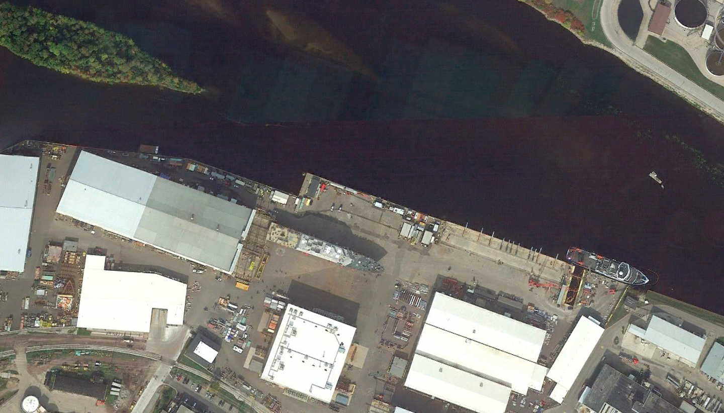 A satellite view of the Fincantieri Marinette Marine shipyard, in Marinette, Wisconsin, with a <em>Freedom</em> class vessel on the waterfront of the Menominee River, awaiting launch. <em>Google Earth</em>
