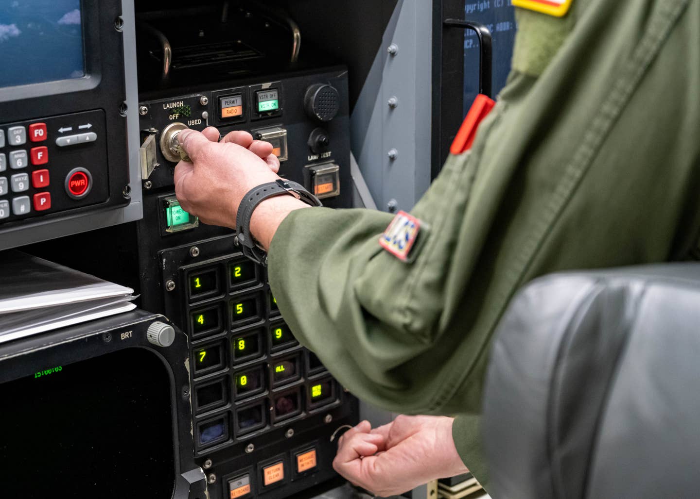 U.S. Air Force Maj. Hayden McVeigh, 625th Strategic Operations Squadron deputy missile combat crew commander-airborne, turns the keys to initiate the launch of an unarmed intercontinental ballistic missile as part of a test on April 19. <em>USAF</em>