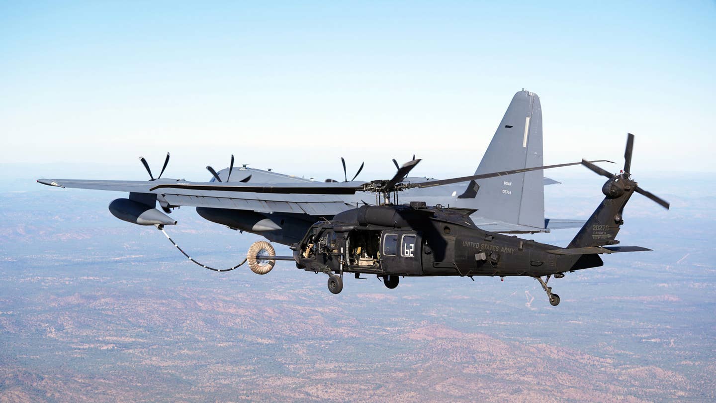 An MC-130J Commando II conducts helicopter air-to-air refueling with an Army MH-60 Black Hawk, both supporting Special Operations Command Pacific, during Talisman Sabre 21 above Queensland, Australia, in 2021. <em>U.S. Air Force photo by 1st Lt. Joshua Thompson</em>