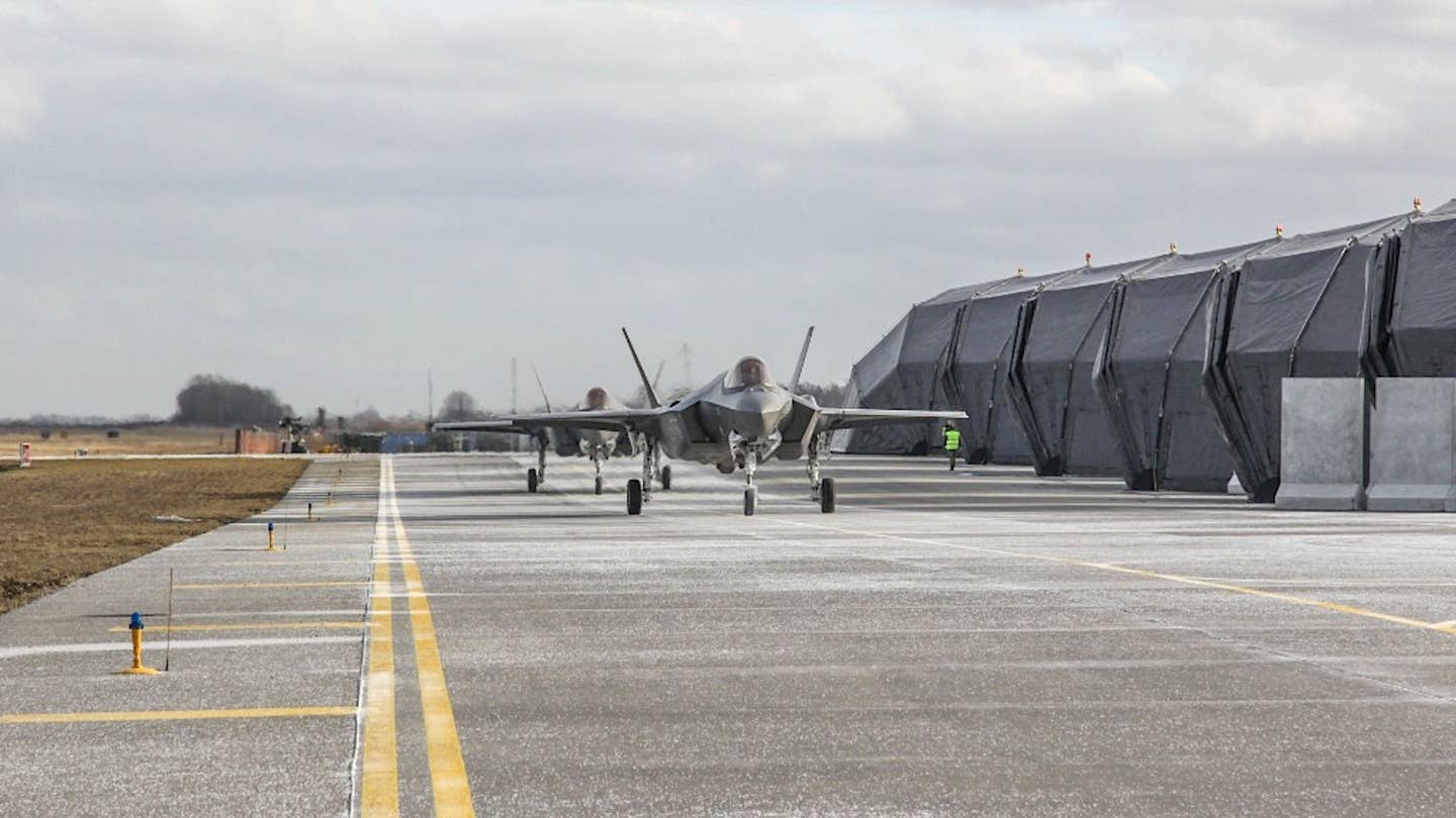 A pair of US Air Force F-35A Joint Strike Fighters at Siauliai Air Base in Lithuania, on Feb. 24, 2022, the day Russia launched its all-out invasion of Ukraine. <em>Lithuanian Air Force</em>