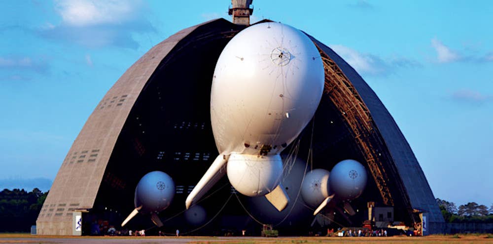 A picture of a hangar belonging to U.S. firm TCOM showing multiple aerostats of different sizes inside. <em>TCOM</em>