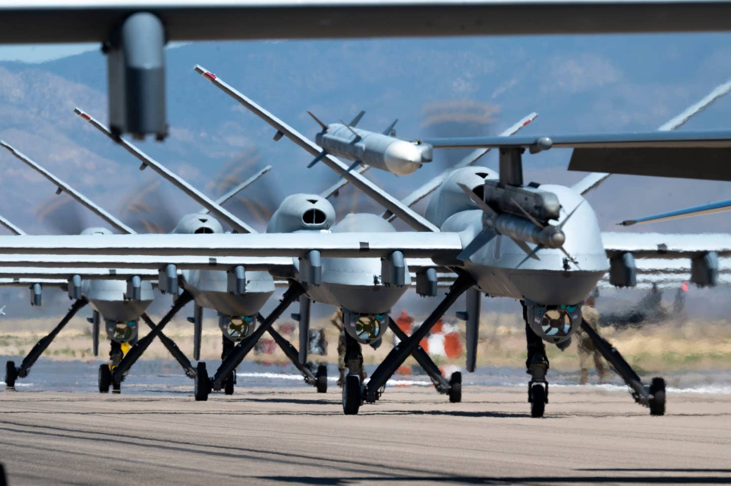 MQ-9s assigned to the 49th Wing line up on the runway during the elephant walk at Holloman Air Force Base. <em>U.S. Air Force photo by Tech. Sgt. Victor J. Caputo</em>