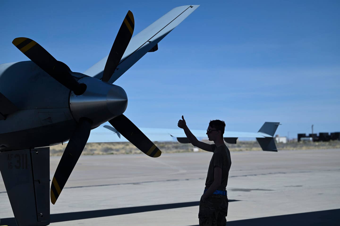 U.S. Air Force Airman 1st Class Kyle Phelps, 9th Aircraft Maintenance Unit maintainer, prepares an MQ-9 for taxi on April 21. <em>U.S. Air Force photo by Airman 1st Class Michelle Ferrari</em><br>
