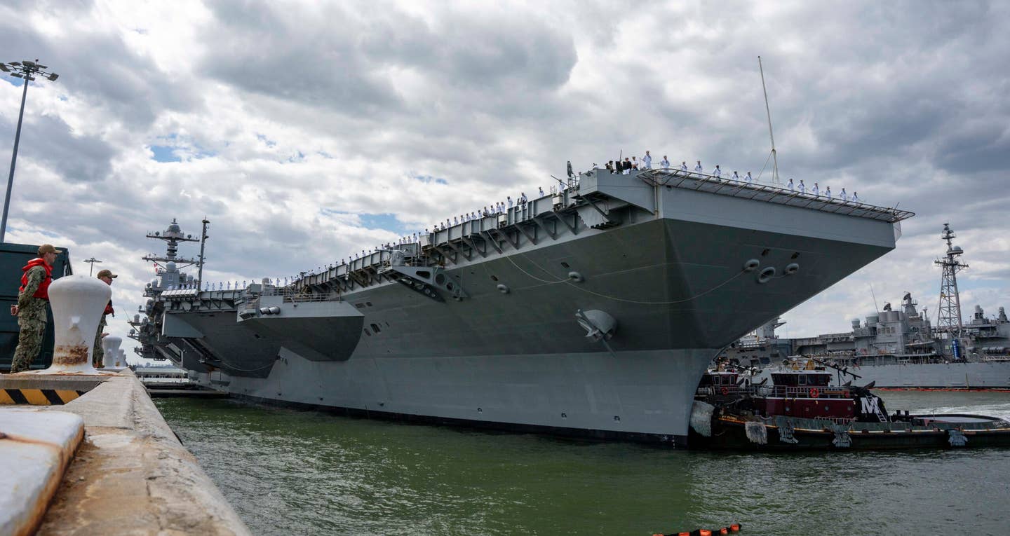 <em>Ford</em> begins to move away from the pier on May 2 as it sets out on its first real operational deployment. <em>USN</em>