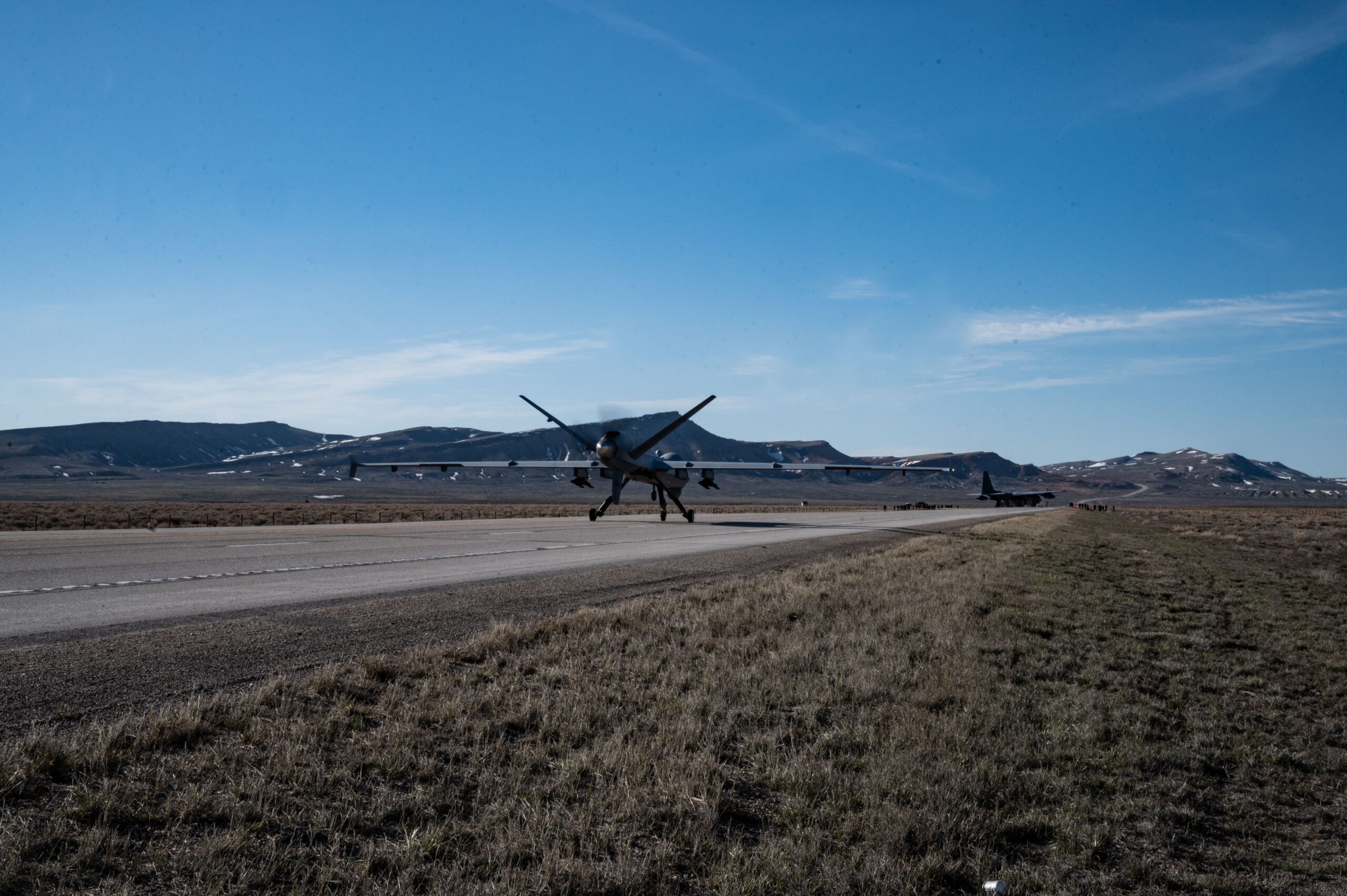 An MQ-9 Reaper lands on Highway 287 during Exercise Agile Chariot, April 30, 2023, honing capabilities linked to Agile Combat Employment. Instead of relying on large, fixed bases and infrastructure, ACE uses smaller, more dispersed locations and teams to rapidly move and support aircraft, pilots, and other personnel to wherever they are needed. There are millions of miles of public roads in the United States, including federal, state, and local roads – with Agile Combat Employment, including Forward Arming and Refueling Point (FARP) and Integrated Combat Turnarounds (ICT), it can become millions of miles of public runways, when necessary. (U.S. Air Force photo by Tech. Sgt. Carly Kavish)