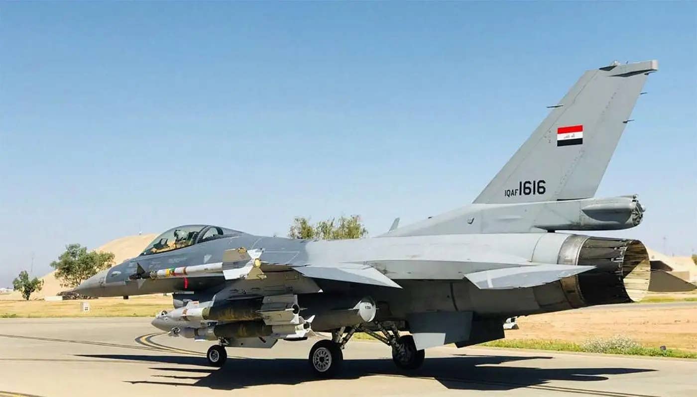 An Iraqi F-16IQ with an AIM-9L/M Sidewinder missile on its left wingtip, as well as a pair of GBU-12/B bombs under its left wing. <em>Iraqi Air Force</em>