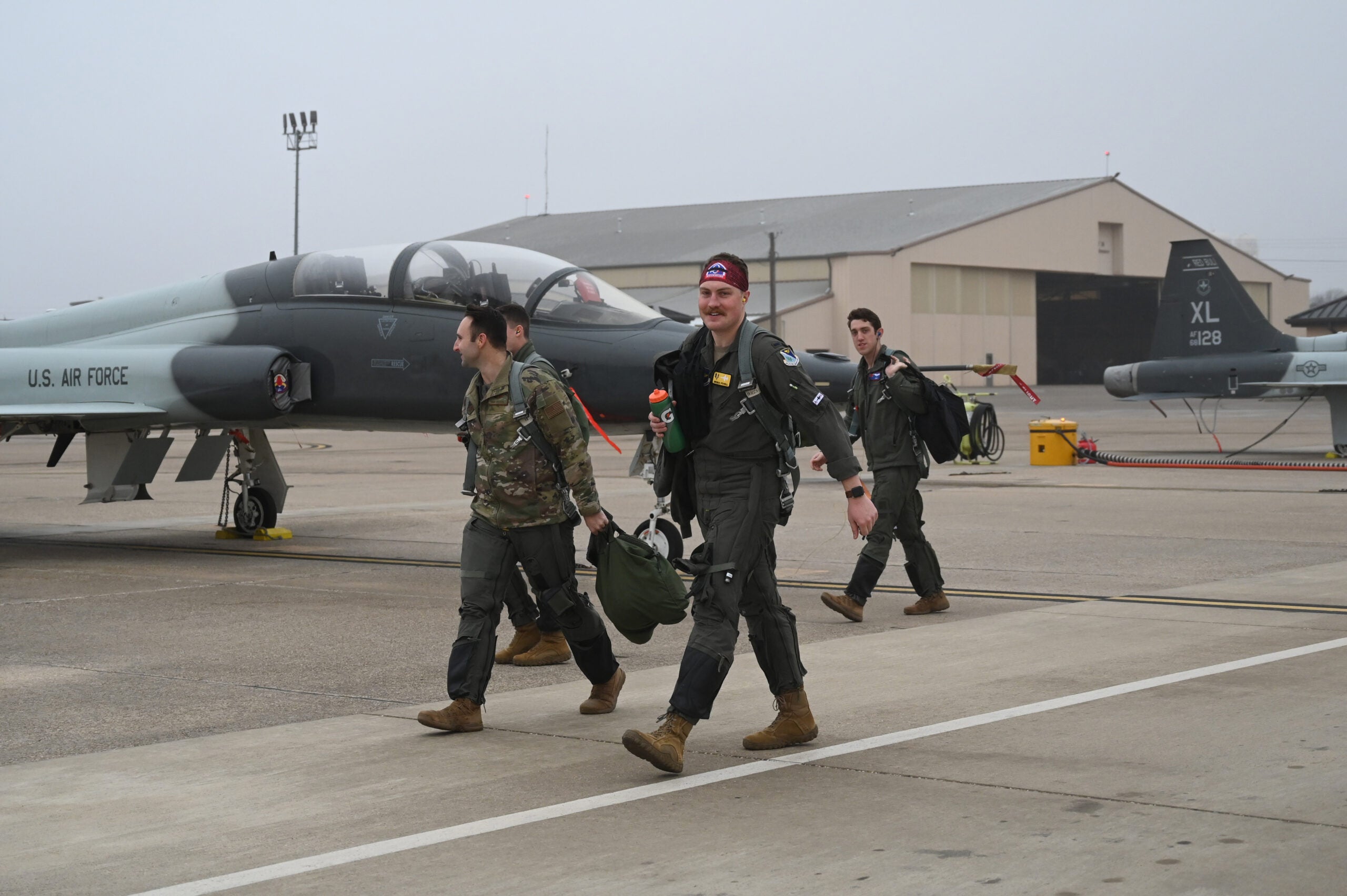 Multiple U.S. Air Force pilots walk to their respective T-38’s on the flight line at Laughlin Air Force Base, Texas on Feb. 2, 2022. Each pilot spends over a year at Laughlin training to become the world’s best pilots, flying the T-6 Texan, and either the T-38 Talon or the T-1 Jayhawk. (U.S. Air Force photo by Airman Kailee Reynolds)