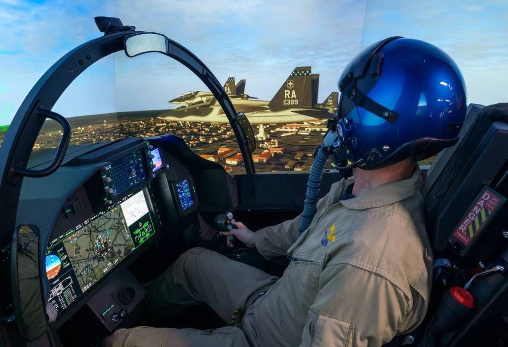 A Boeing test pilot at the controls of a virtual T-7 in the simulator. Note its advanced wide area display-based cockpit. (Boeing)
