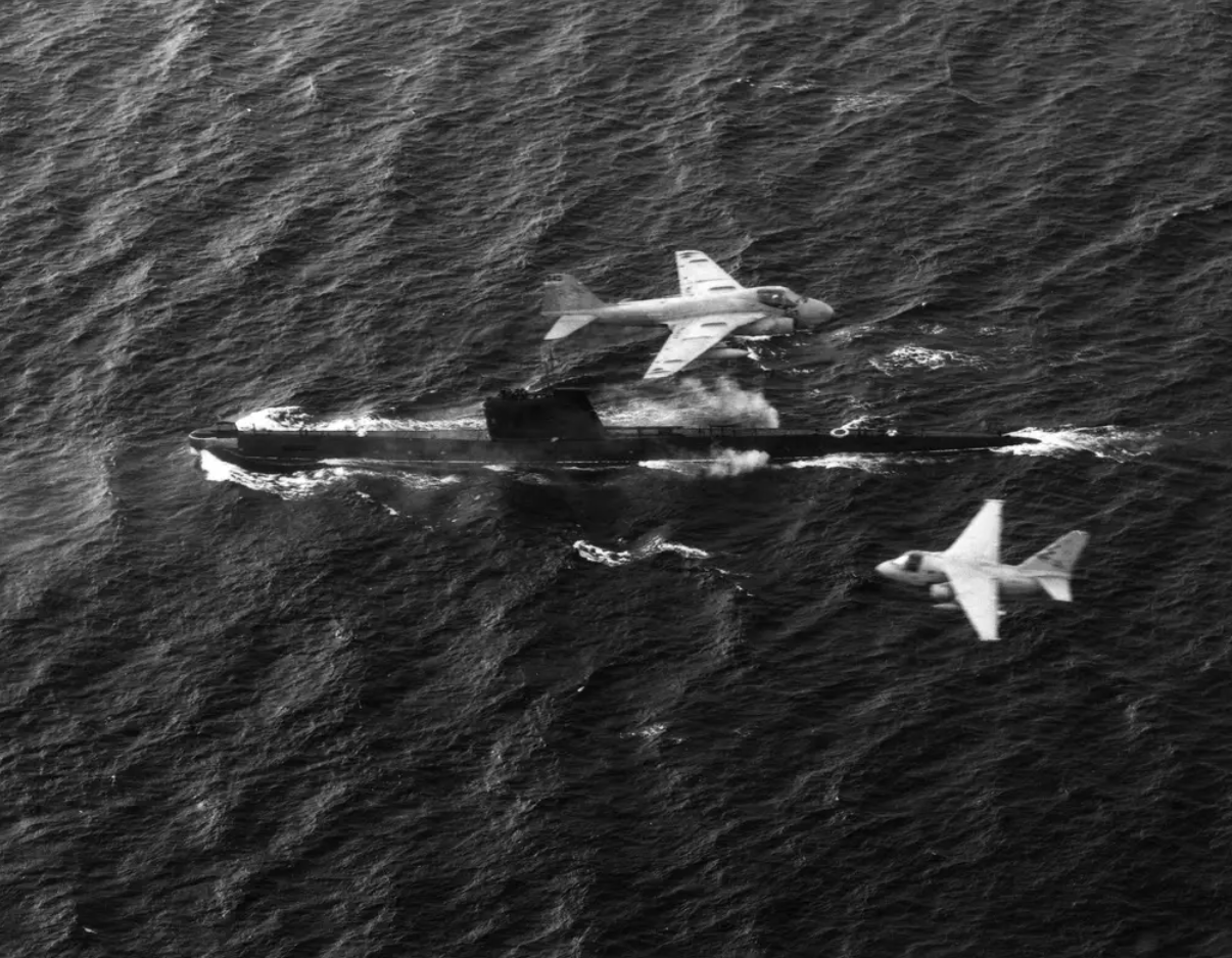 An S-3 Viking and A-6 Intruder from the USS&nbsp;<em>John F. Kennedy</em>&nbsp;(CV-67) fly over a Soviet&nbsp;<em>Foxtrot</em>&nbsp;class diesel submarine.&nbsp;<em>U. S. Navy</em>