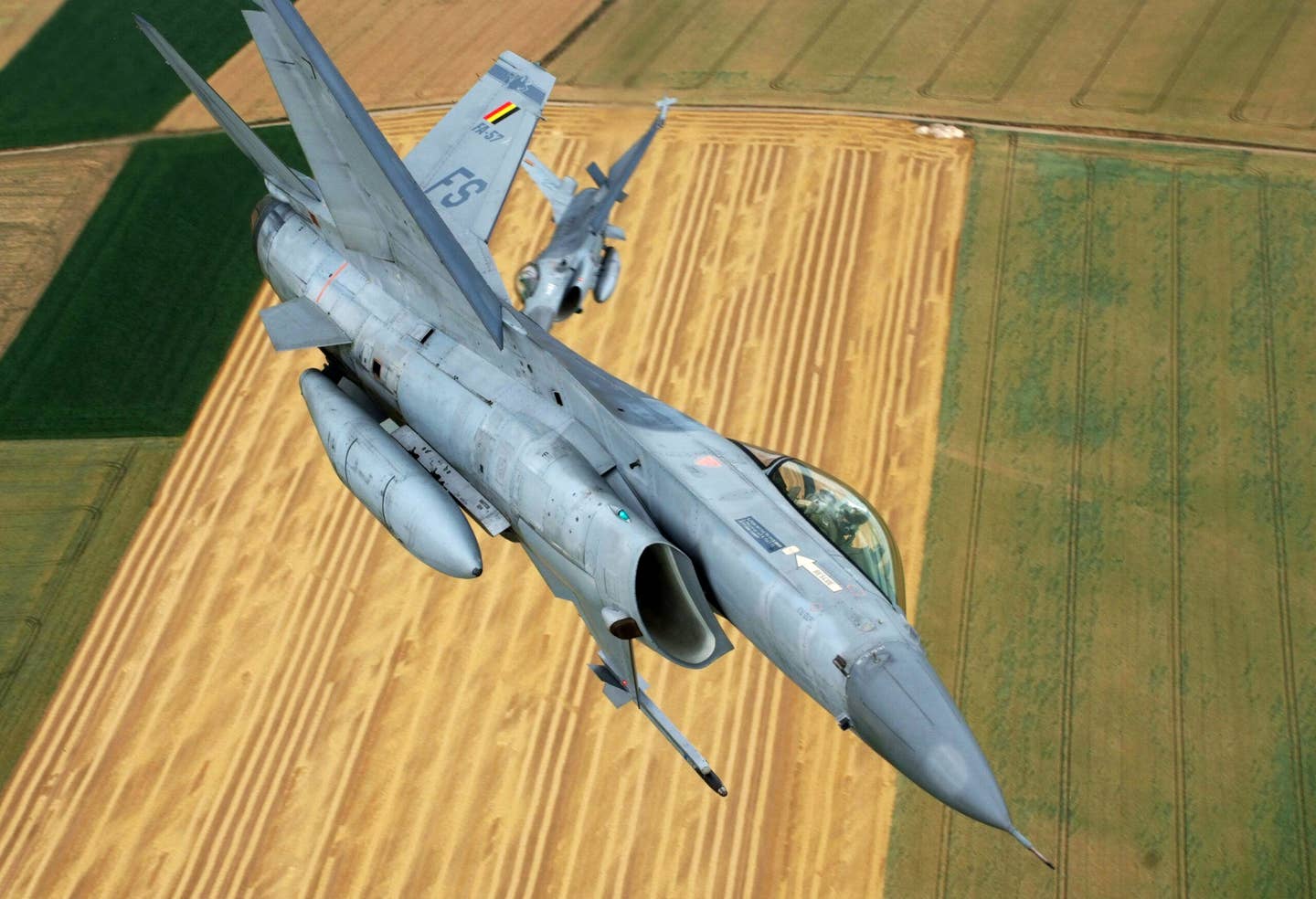 Two Belgian Air Force F-16 fighter jets during a rehearsal flight for the national parade in Florennes, on July 16, 2010. <em>GERARD GAUDIN/AFP via Getty Images</em>