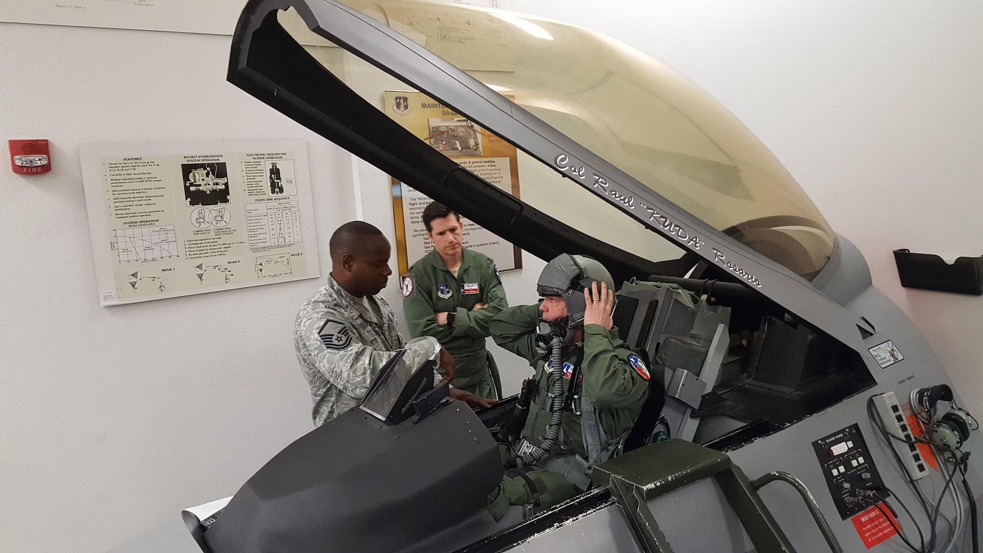 An F-16 pilot sits in a cockpit mockup during egress training on the ground. This training teaches pilots to get in and out of the cockpit safely in various situations, including if they need to eject in an emergency. USAF U.S. Air Force