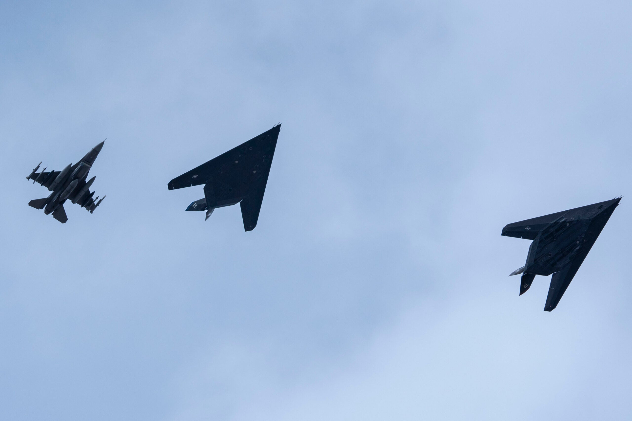 Two U.S. Air Force F-117 Nighthawks escorted by a F-16 Fighting Falcon assigned to the 42nd Test and Evaluation Squadron, Nellis Air Force Base, New Mexico, prepare to land during Northern Edge 23-1 at Joint Base Elmendorf-Richardson, Alaska, May 10, 2023. Northern Edge 23-1 provides an opportunity for joint, multinational and multi-domain operations designed to implement high-end, realistic war fighter training, develop and improve joint interoperability, and enhance the combat readiness of participating forces. (U.S. Air Force photo by Airman 1st Class Julia Lebens)