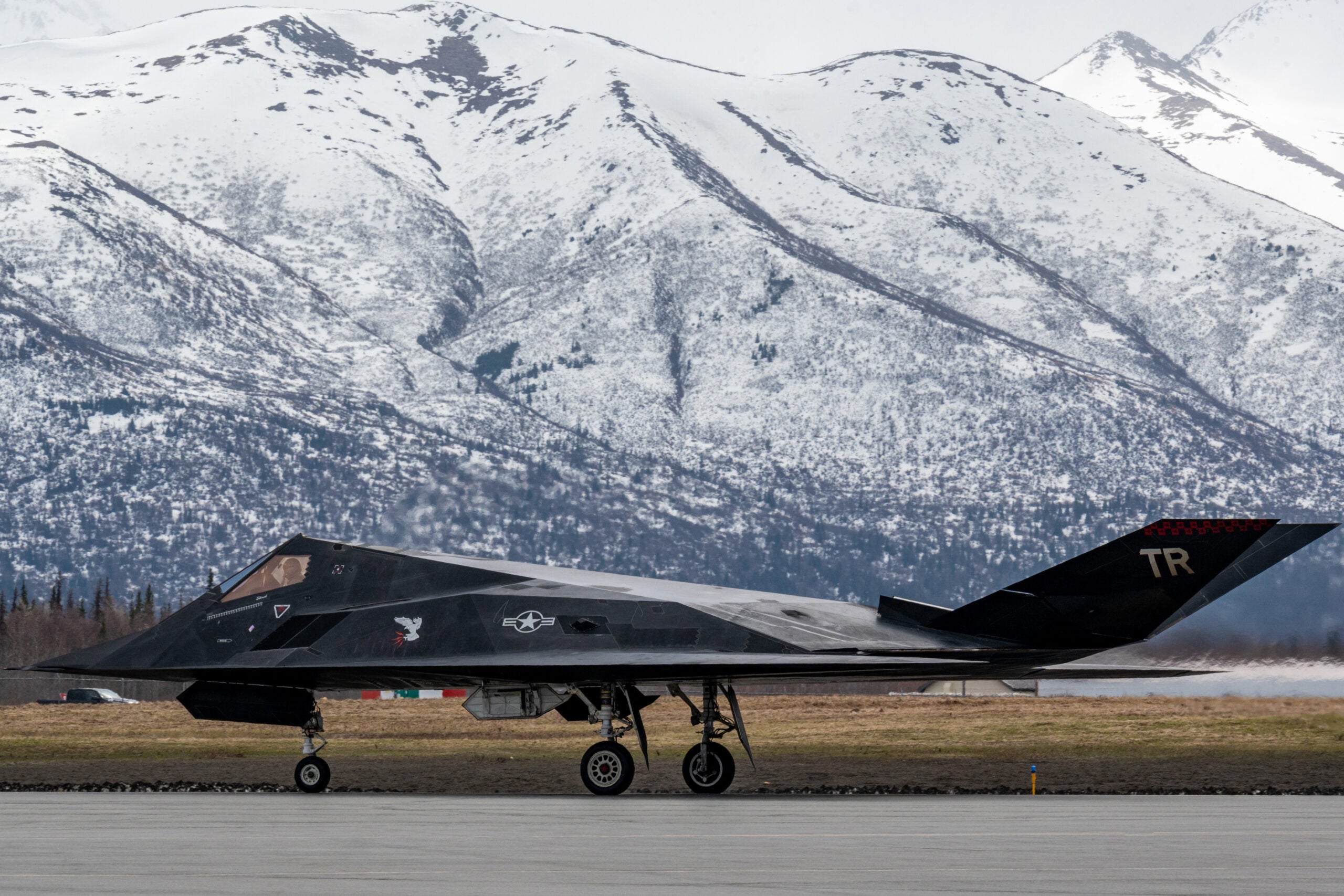 A U.S. Air Force F-117 Nighthawk lands at Joint Base Elmendorf-Richardson, Alaska during Northern Edge 23-1, May 10, 2023. NE 23-1 provides an opportunity for joint, multinational and multi-domain operations designed to implement high-end, realistic war fighter training, develop and improve joint interoperability, and enhance the combat readiness of participating forces. (U.S. Air Force photo by Sheila deVera)