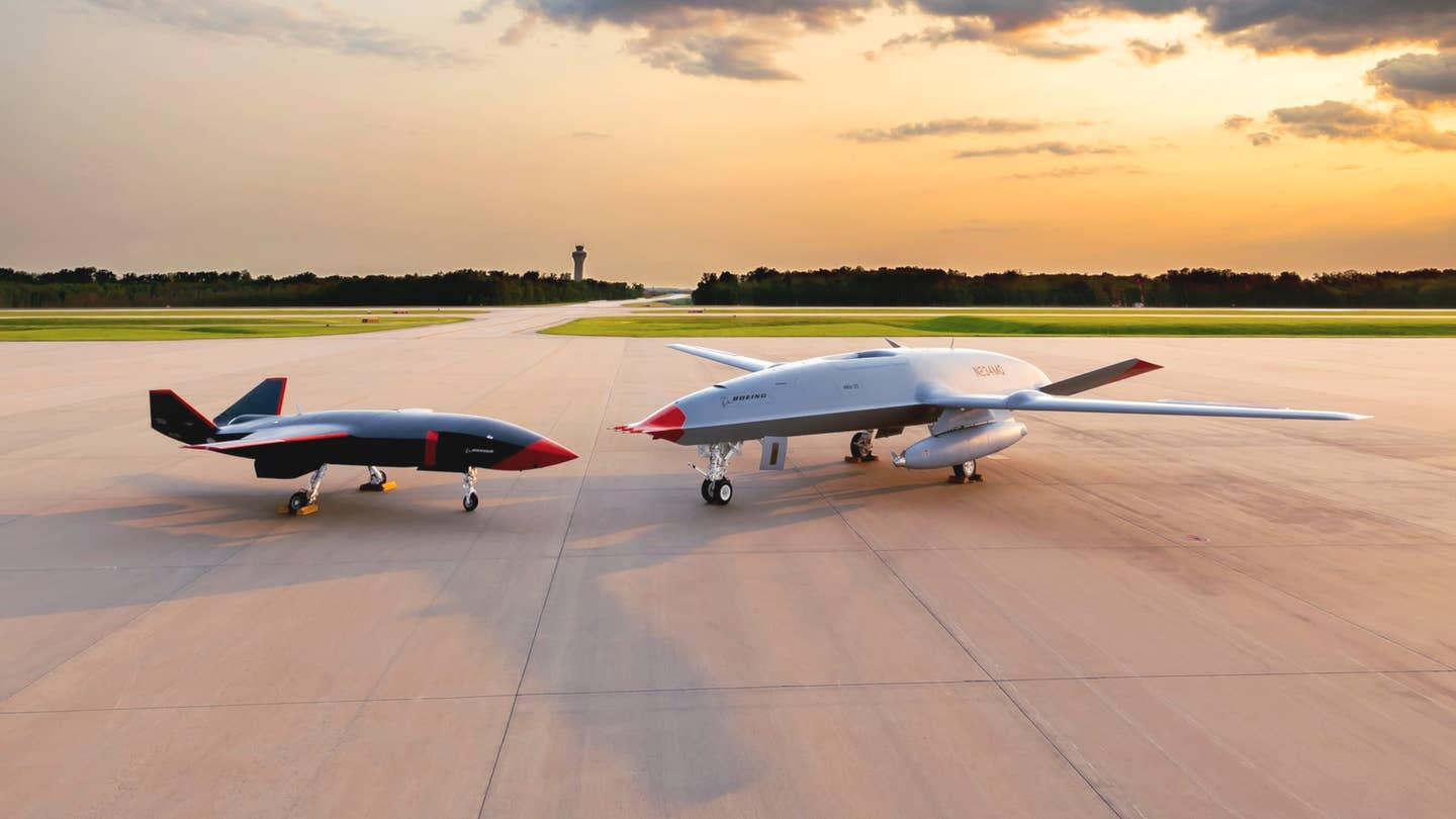 An MQ-28 Ghost Bat, at left, alongside the demonstrator Boeing has been using to help with the development of the MQ-25 Stingray tanker drone for the U.S. Navy, at MidAmerica Airport. <em>Boeing</em>