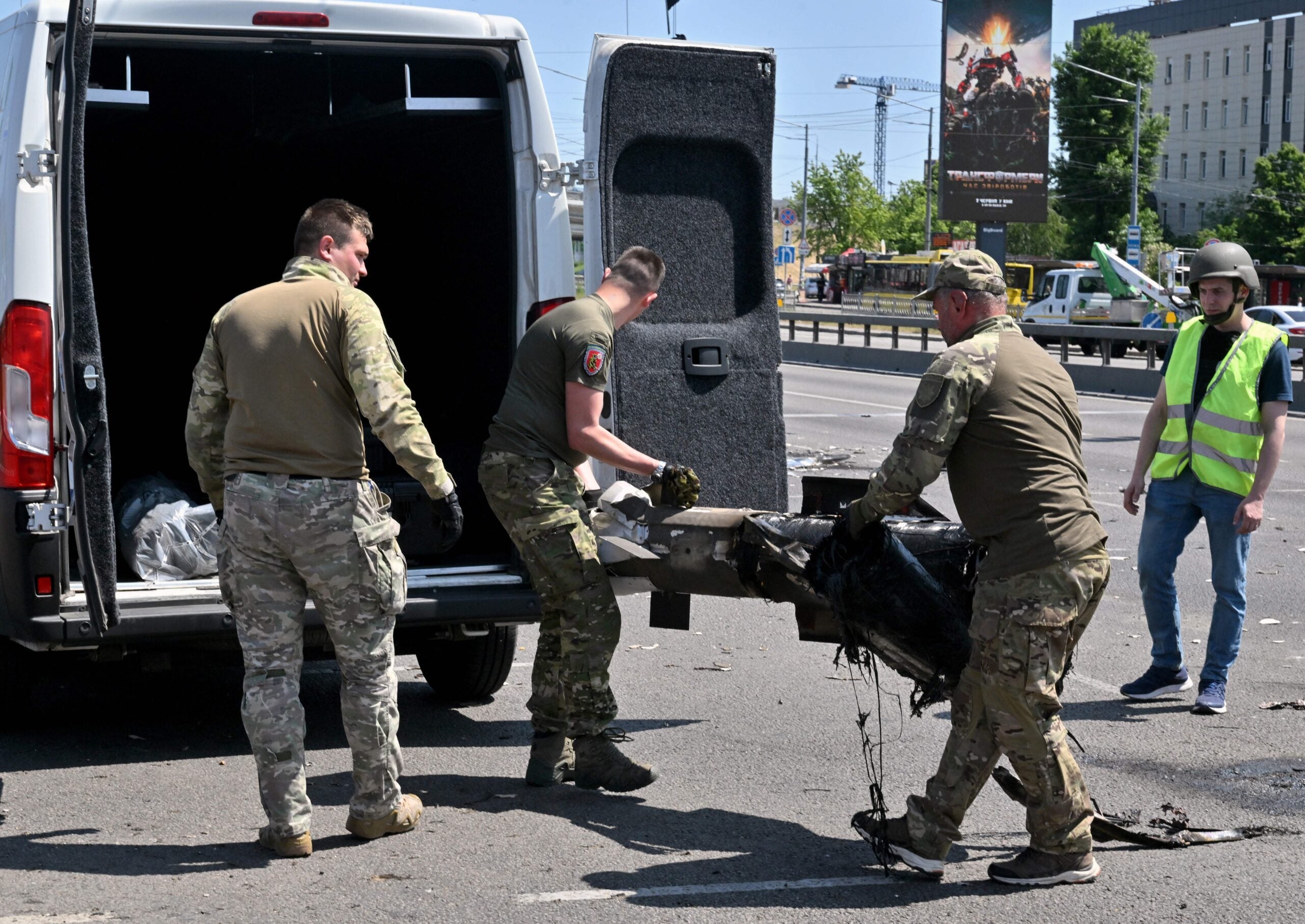 Police experts load fragments of a missile into a car after Russia fired a barrage of missiles for the second time in 24 hours, in an unusual daytime attack targetting the Ukrainian capital following overnight strikes, in Kyiv, on May 29, 2023. "A total of 11 missiles were fired: 'Iskander-M' and 'Iskander-K' from a northerly direction," Ukraine's armed forces chief Valery Zaluzhny said, adding that "all the targets were destroyed by air defences" (Photo by Sergei SUPINSKY / AFP) (Photo by SERGEI SUPINSKY/AFP via Getty Images)