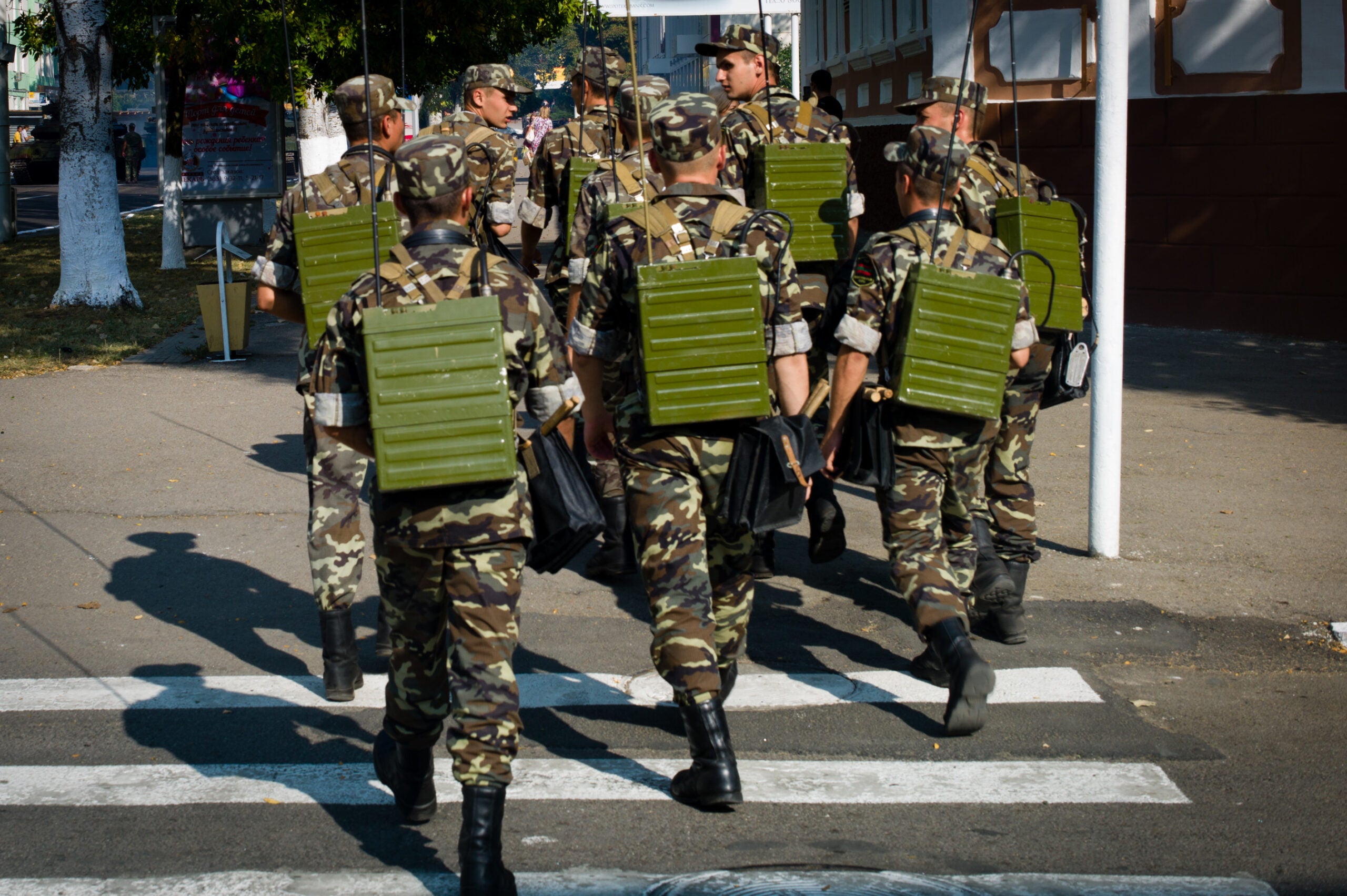 201508231 Moldova, Transnistria,Pridnestrovian Moldavian Republic (PMR) Tiraspol.Soldiers cross the street with communication material on their backs. They exercise for the official 25th anniversary of their unrecognized country, on september 2. (Photo by Sander de Wilde/Corbis via Getty Images)