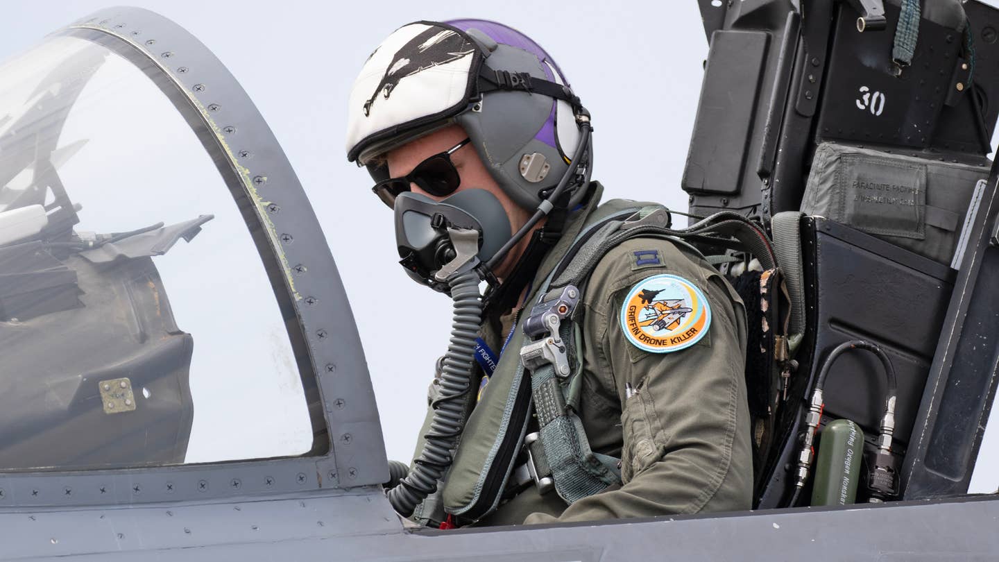 This California Air National Guard F-15C pilot from the 194th Fighter Squadron "Griffins" wears a "Drone Killer" patch that shows a QF-16 being "killed" by an AMRAAM. <em>Richard Collens</em>