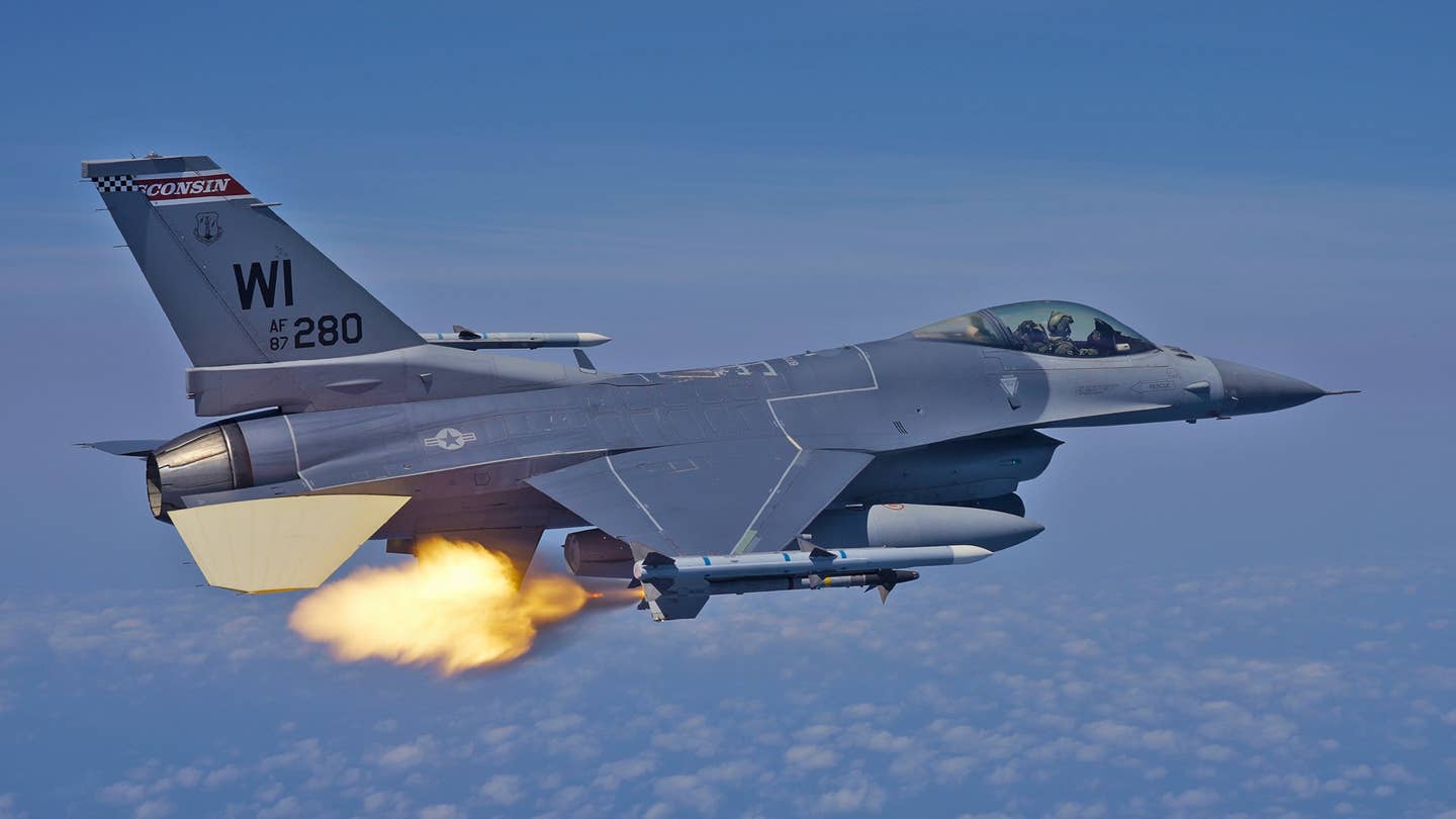 The rocket motor on an AIM-9M fires before the missile rushes off the rail. <em>Jamie Hunter</em>