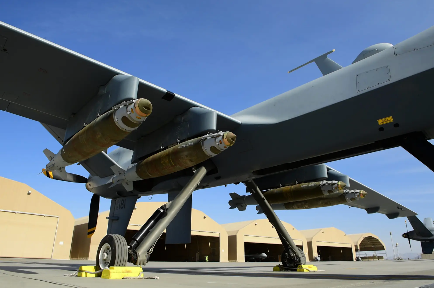 A U.S. Air Force MQ-9 Reaper, assigned to the 62nd Expeditionary Reconnaissance Squadron, armed with four GBU-38 JDAMs on a flight line at a deployed location.&nbsp;<em>U.S. Air Force Photo by Tech. Sgt. Paul Labbe</em><br>