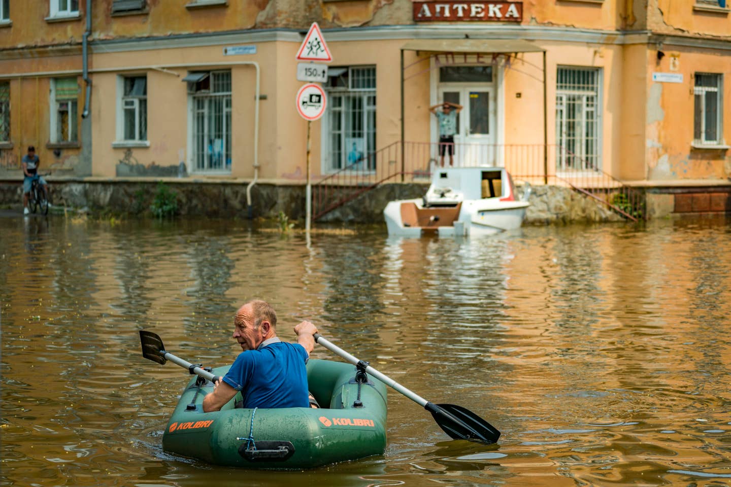 A man rows with a small boat among the flooded streets in Kherson city because the collapsed Nova Kakhovka dam upstream the Dnipro river. (Photo by Celestino Arce/NurPhoto via Getty Images)