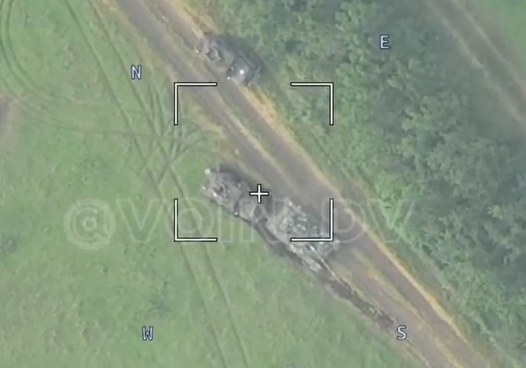 Ukrainian T-72 tank is pushing an MRAP. (VOIN DV video screencap)