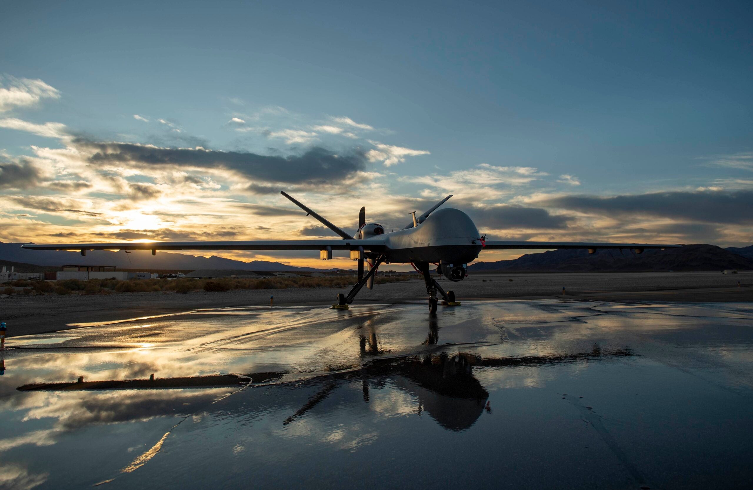 An MQ-9 Reaper sits on the runway during sunset at Creech Air Force Base, Nev., Nov. 17, 2020. Using satellite communication links, the MQ-9 can acquire and pass real-time imagery data to ground users around the clock and beyond line of sight. (U.S. Air Force photo by Staff Sgt. Lauren Silverthorne)