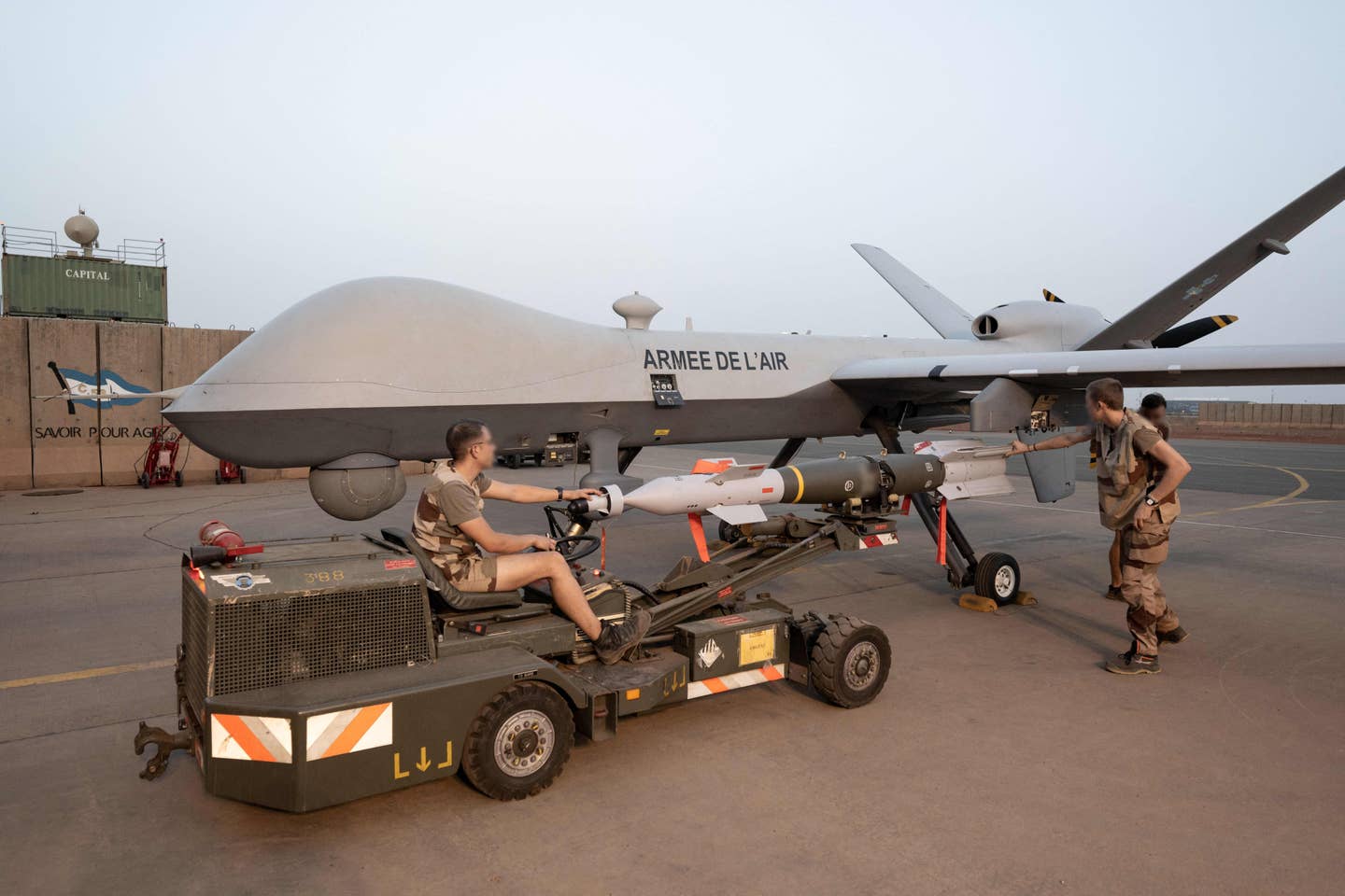 French soldiers remove a laser-guided bomb from a Reaper drone after a mission at the French airbase in Niamey, in Niger, on May 14, 2023. <em>Photo by ALAIN JOCARD/AFP via Getty Images</em>