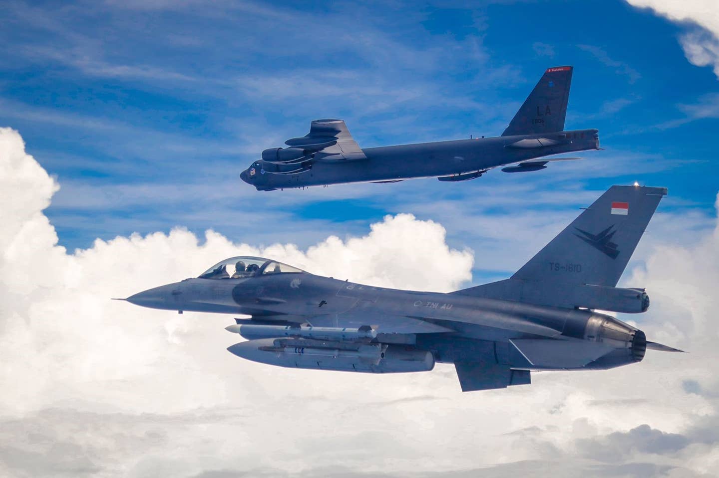 An Indonesian Air Force F-16 flies next to a U.S. Air Force B-52 Stratofortress assigned to the 2nd Bomb Wing, Barksdale Air Force Base, Louisiana, in the Indo-Pacific region, September 1, 2021. <em>Indonesian Air Force</em>