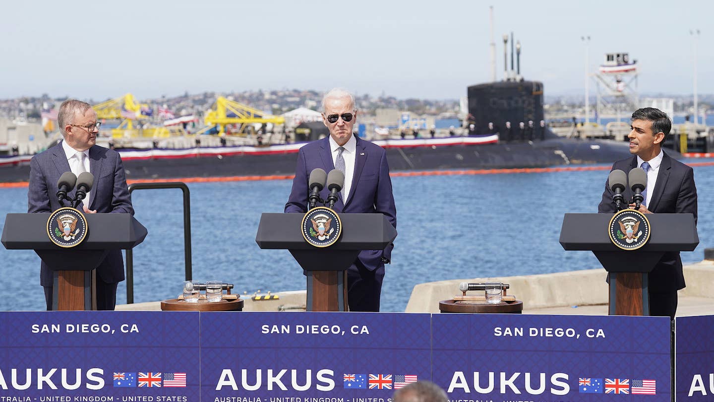 The leaders of the AUKUS nations – from left to right, Australian Prime Minister Anthony Albanese, US President Joe Biden, and UK Prime Minister Rishi Sunak – at a press conference at the U.S. Navy's Naval Base Point Loma in San Diego on March 13, 2023. The U.S. Navy's <em>Virginia</em> class submarine USS <em>Missouri</em> is seen in the background. <em>Stefan Rousseau/Pool via AP</em>