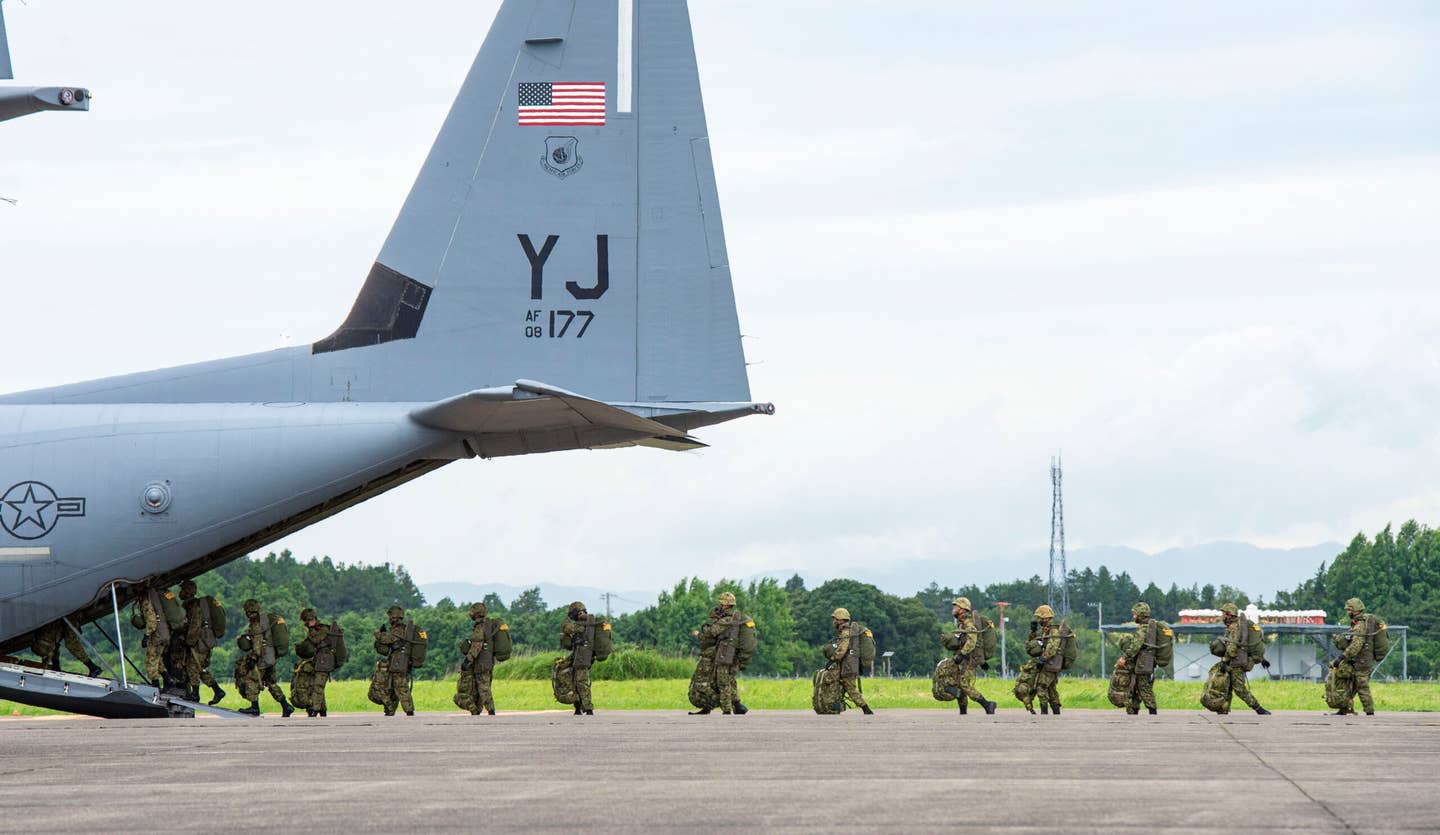 Japan Ground Self-Defense Force paratroopers board a C-130J assigned to the 36th Airlift Squadron out of Yokota Air Base, Japan, at Hyakuri Air Base, Japan, July 9, 2020. <em>U.S. Air Force photo by Staff Sgt. Gabrielle Spalding</em>