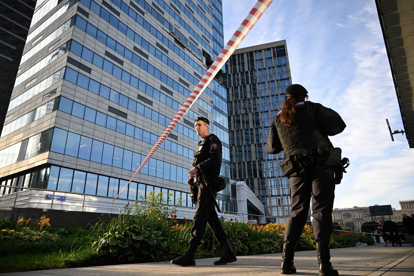 Police officers block off an area around a damaged office block of the Moscow International Business Center (Moskva City) following the drone attack in Moscow on July 30, 2023. <em>Photo by ALEXANDER NEMENOV/AFP via Getty Images</em>