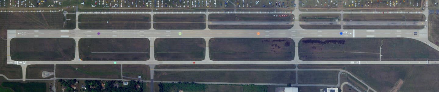 Two of three of Wittman's runways adorned with colored dots. (<em>PHOTO © 2023 PLANET LABS INC. ALL RIGHTS RESERVED. REPRINTED BY PERMISSION</em>)