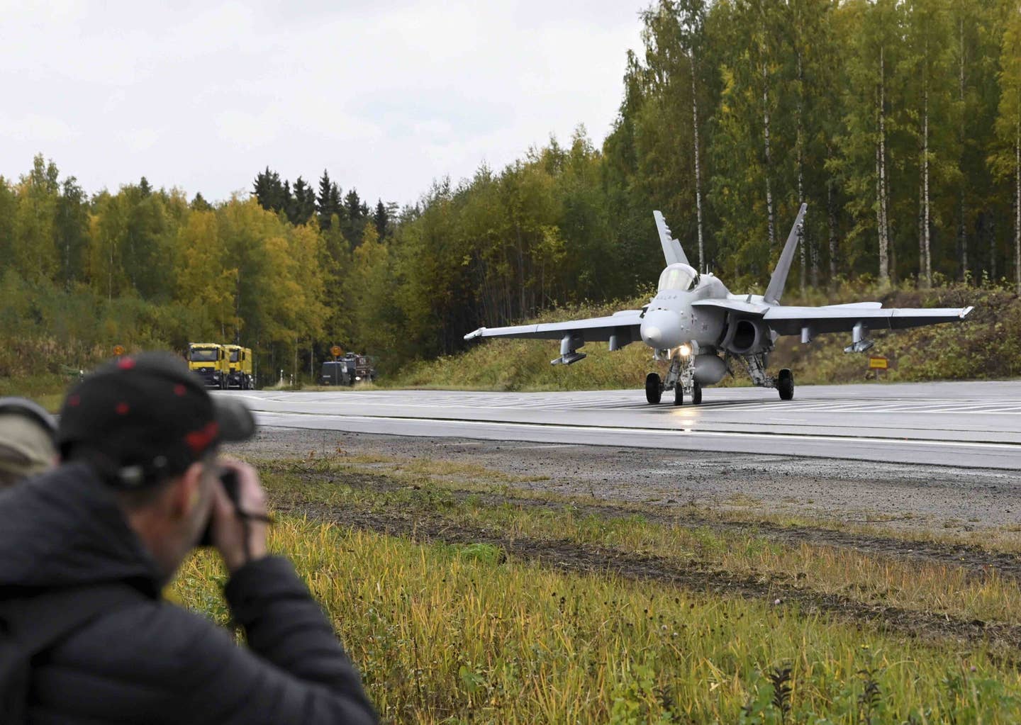 A Finnish Air Force F/A-18 Hornet gets ready to take off from the E4 Highway in Joutsa, Central Finland during the Baana 2022 training event on September 28, 2022. <em>Photo by MARKKU ULANDER/Lehtikuva/AFP via Getty Images</em>