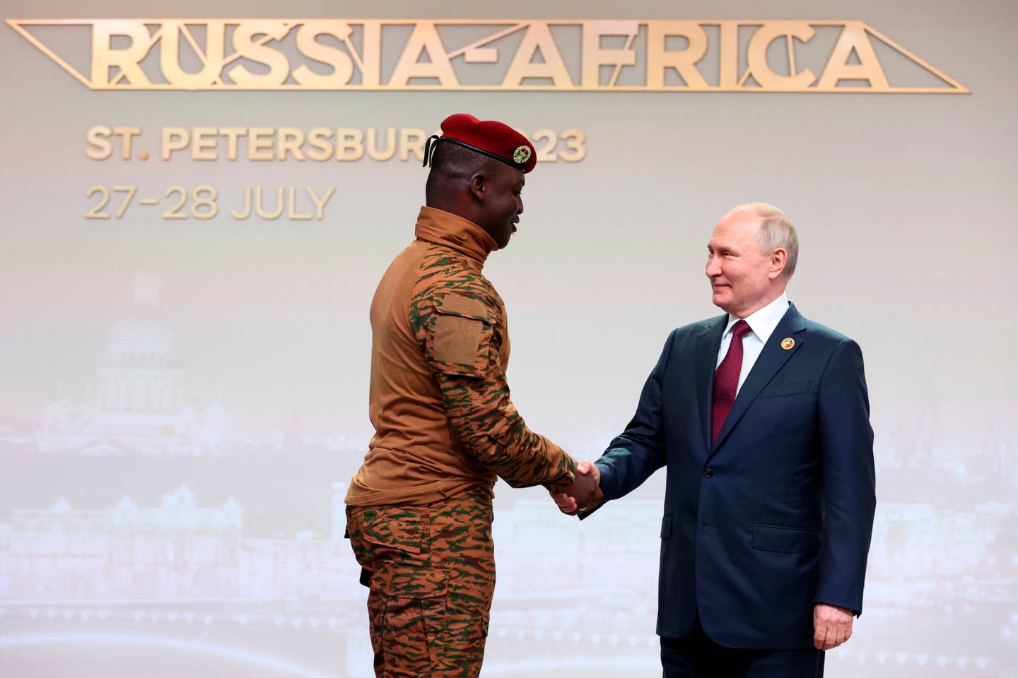 Burkina Faso's Capt. Ibrahim Traore, left, and Russian President Vladimir Putin shake hands before an official ceremony to welcome the leaders of delegations to the Russia Africa Summit in St. Petersburg, Russia, Thursday, July 27, 2023. (Sergei Bobylev/TASS Host Photo Agency Pool Photo via AP)