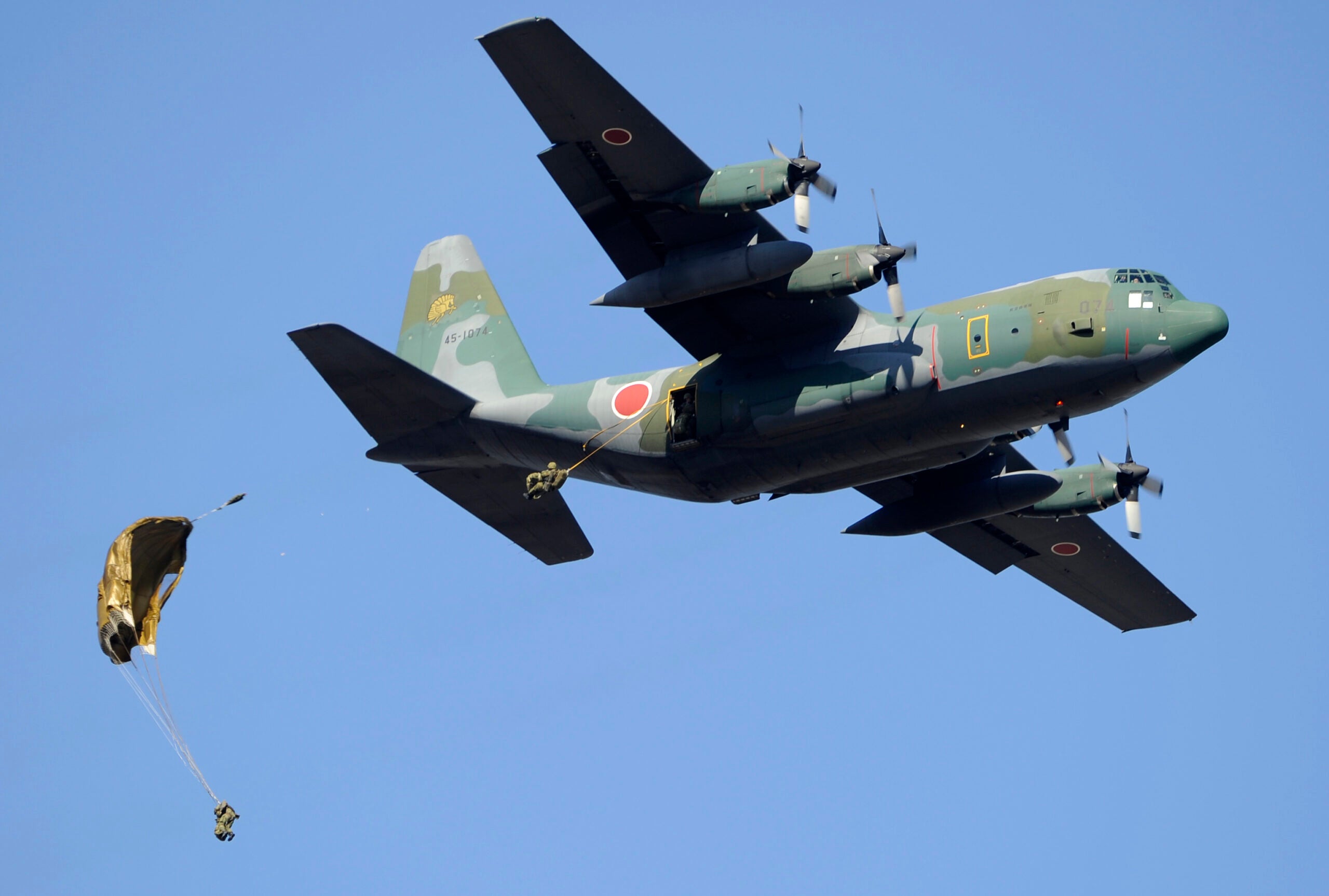 Japanese Ground Self Defense forces' airbone troop personnels dive from a C-130 transport plane during the new year drill in Narashino city in the Chiba prefecture on the outskirt of Tokyo on January 8, 2012. A total of 400 personnels, 18 aircrafts and 41 vehicles took part in the open exercise at the defense forces' Narashino training ground.      AFP PHOTO / TOSHIFUMI KITAMURA (Photo credit should read TOSHIFUMI KITAMURA/AFP via Getty Images)