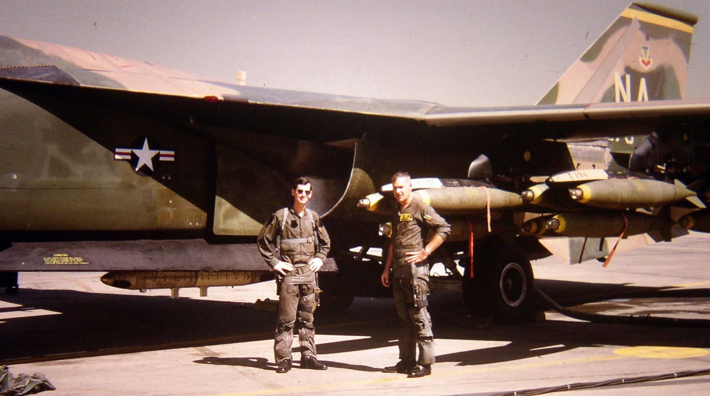 Airmen with the 474th TFW stand in front of an F-111A before a mission. <em>U.S. Air Force</em>