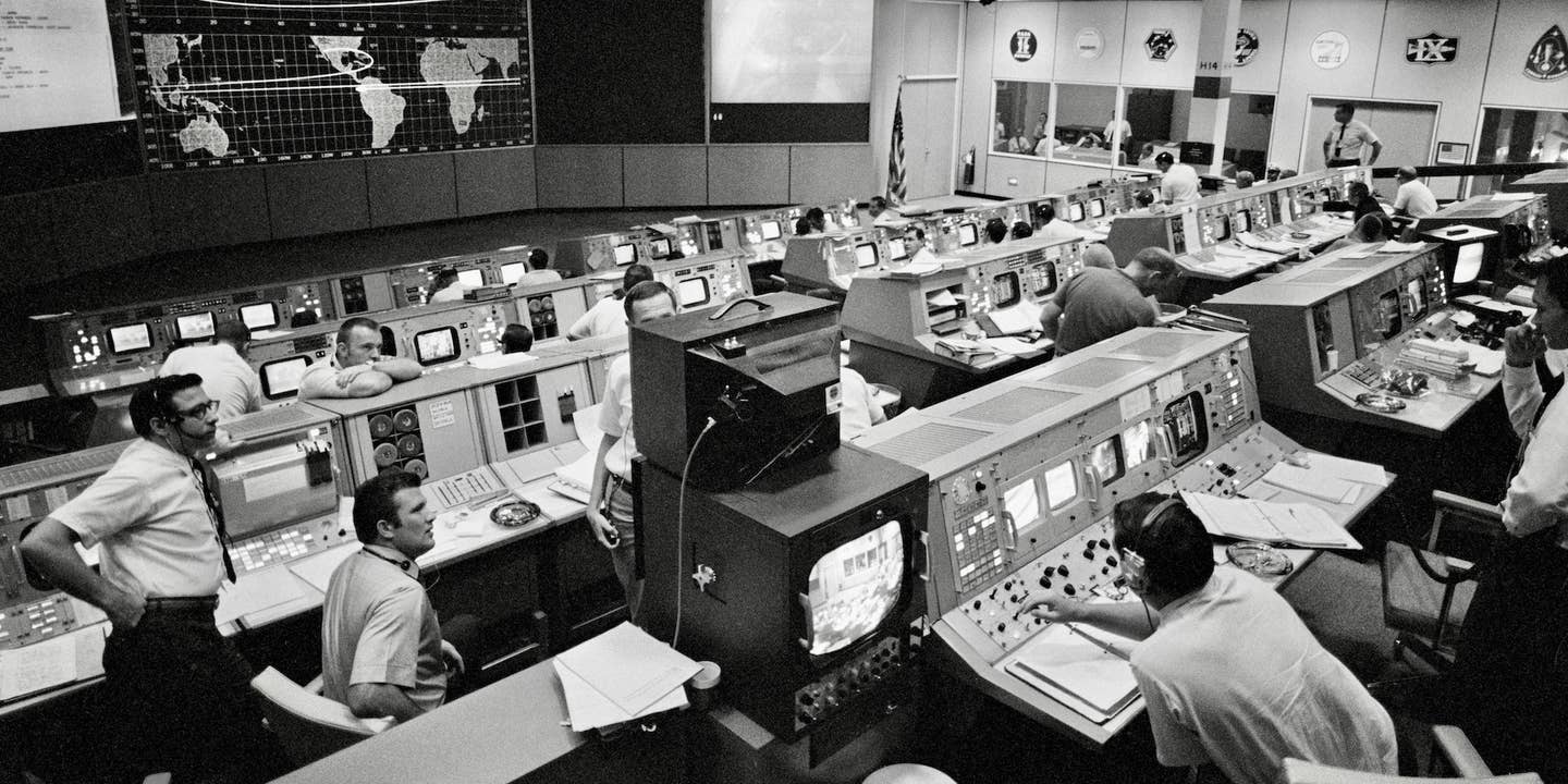 Mission Operations Control Room (MOCR) activities during Apollo 11's re-entry on July 24, 1969. NASA