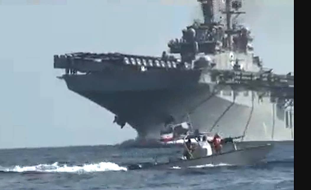 A grainy screen capture showing an Iranian boat zipping around near the USS <em>Bataan</em> in the Strait of Hormuz on August 17, 2023. <em>IRGC capture via Tasnim News Agency</em>