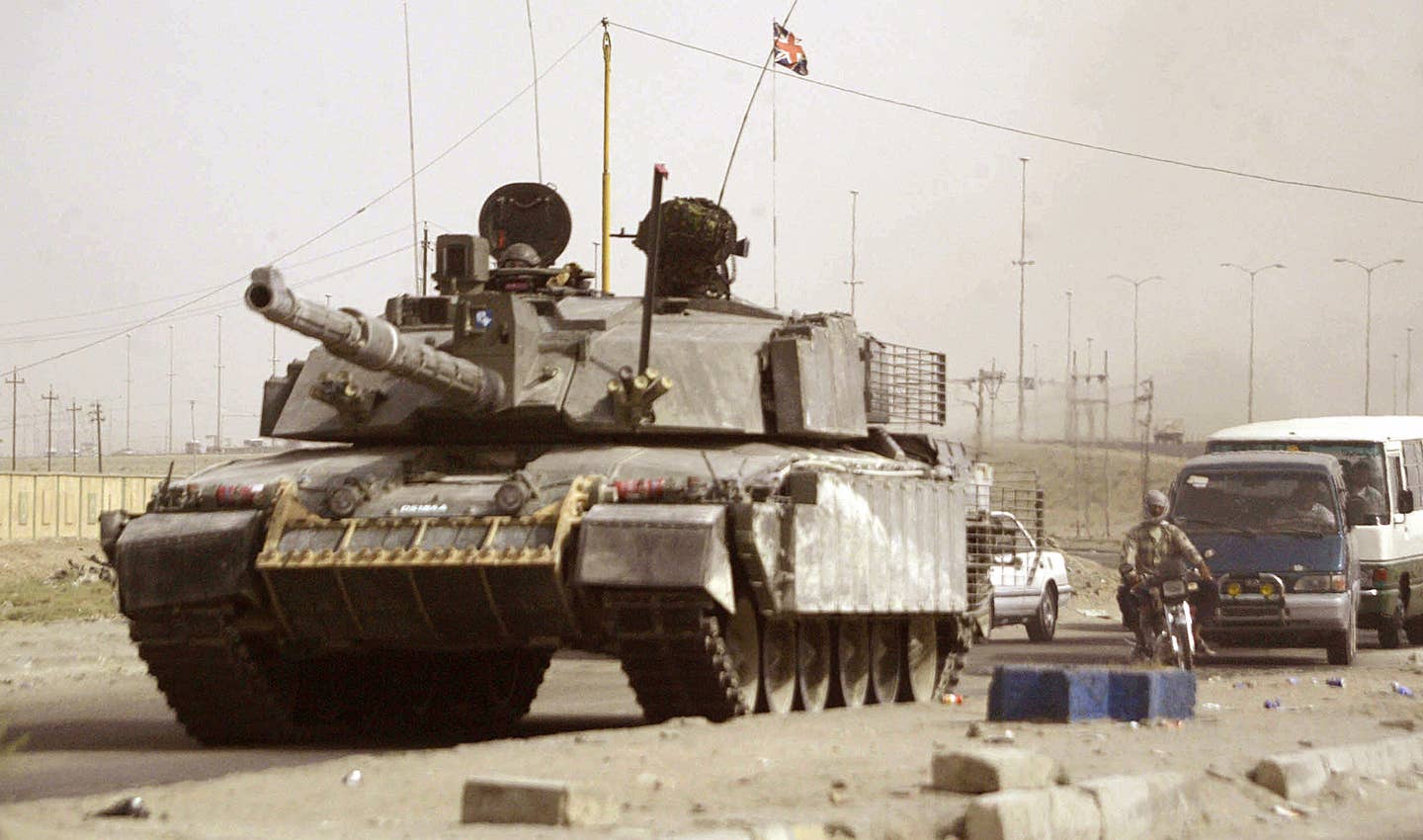 A British Challenger 2 tank rolls into Basra, Iraq, in August 2006. <em>ESSAM AL-SUDANI/AFP via Getty Images</em>