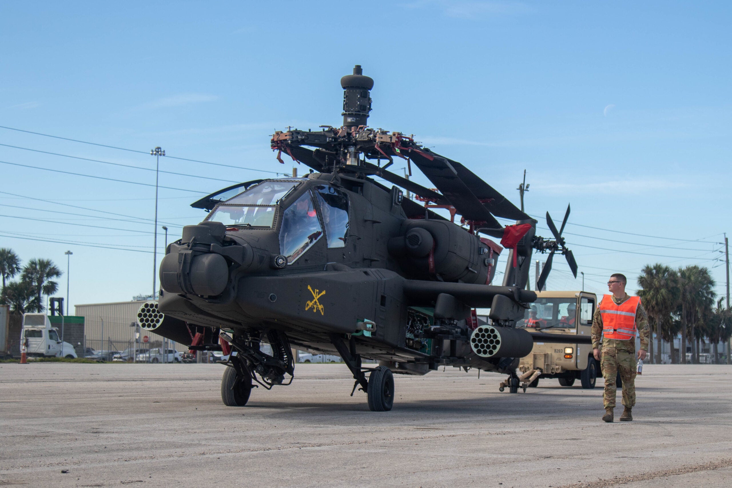 Soldiers assigned to the 3rd Combat Aviation Brigade, 3rd Infantry Division, move an AH-64 Apache to a staging area in the Jacksonville, Florida, port after folding the blades as part of port operations Feb. 14, 2023. 3rd CAB is preparing to support Atlantic Resolve, a nine-month rotation that provides rotational deployments of combat-credible forces to Europe to show our commitment to NATO while building readiness, increasing interoperability and enhancing the bonds between ally partner militaries (U.S. Army photo by Sgt Caitlin Wilkins, 3rd Combat Aviation Brigade)