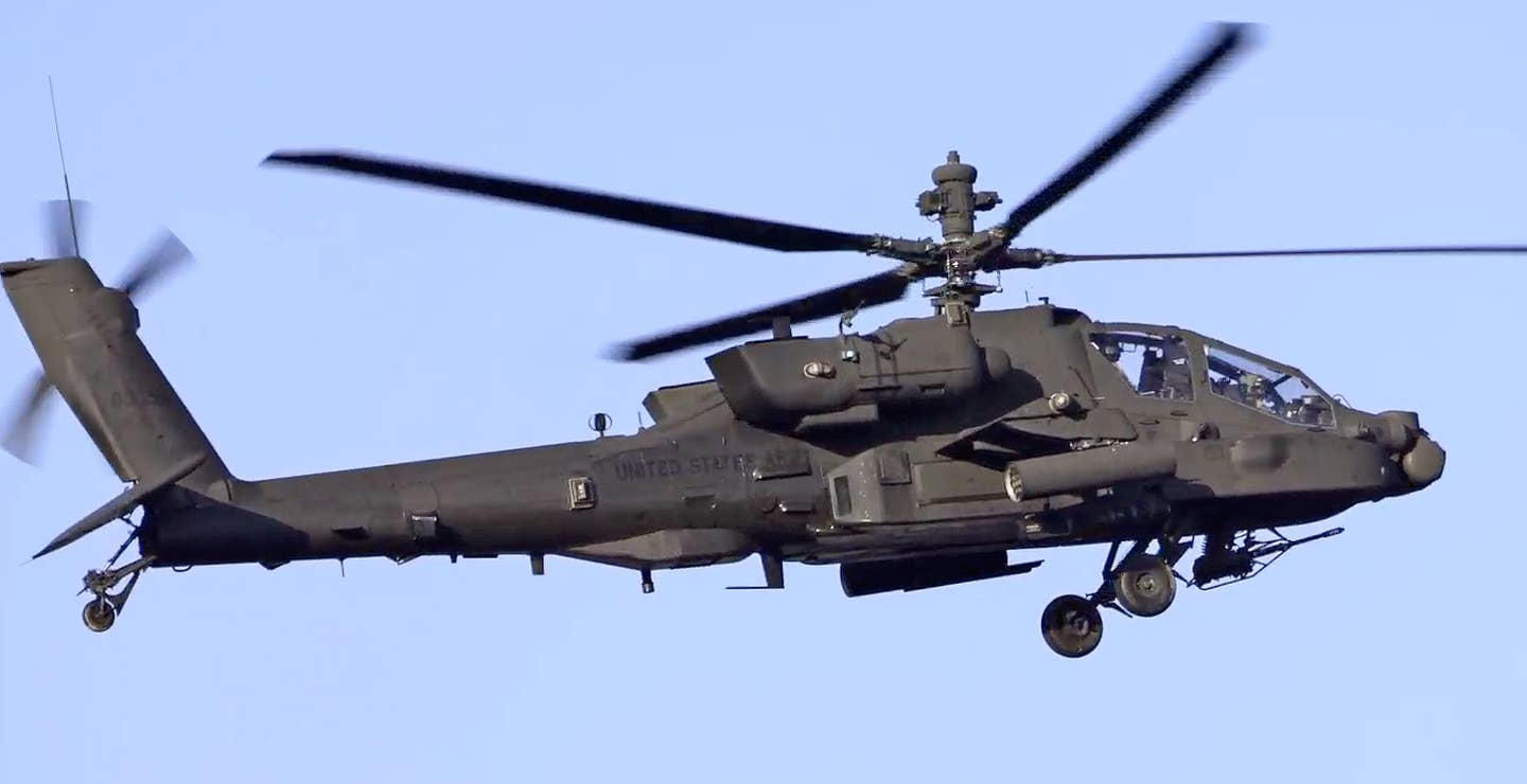 An AH-64E with attachments to its MUMT-X rotor mast. (US Army video screencap)