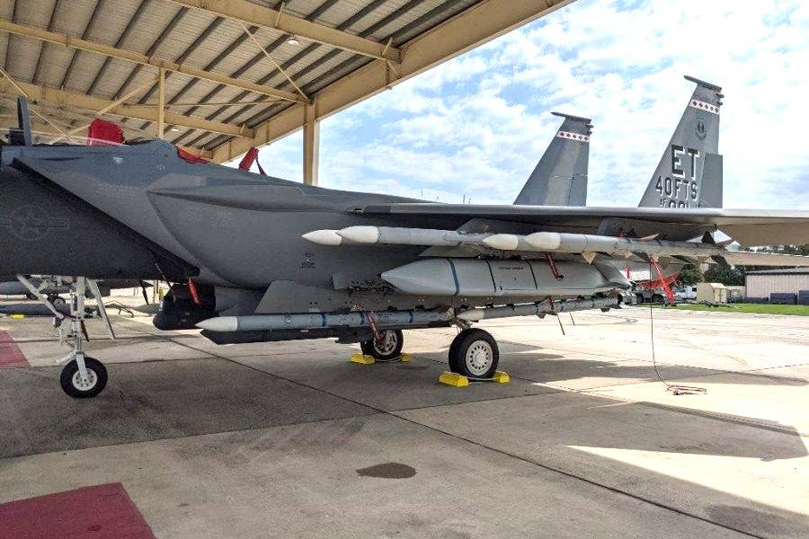 A picture of a heavily laden F-15EX loaded with AIM-120s and AGM-158s during the initial round of operational test and evaluation. <em>USAF</em>