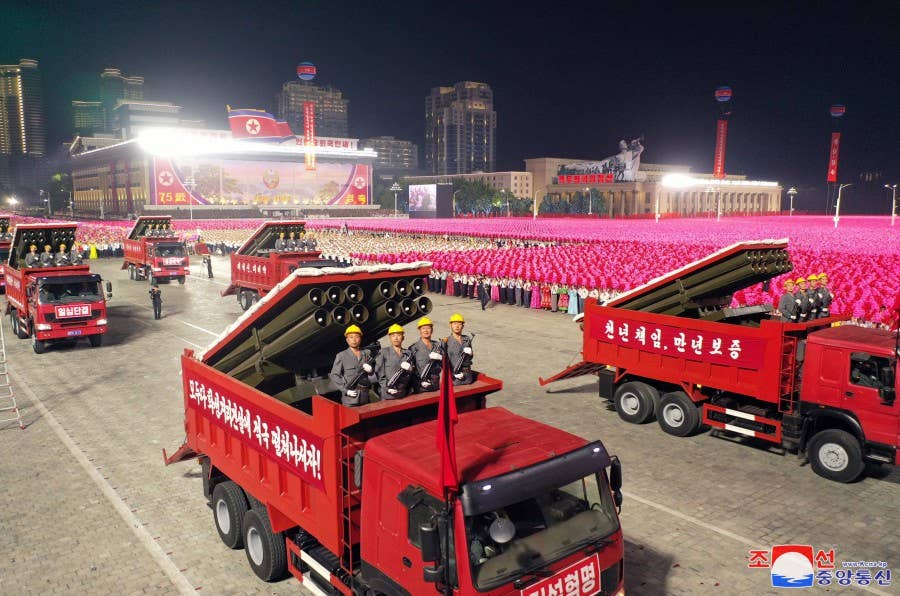 Worker-Peasant Red Guard rocket launchers disguised as dump trucks during a parade in Pyongyang on September 9. <em>KCNA</em>.