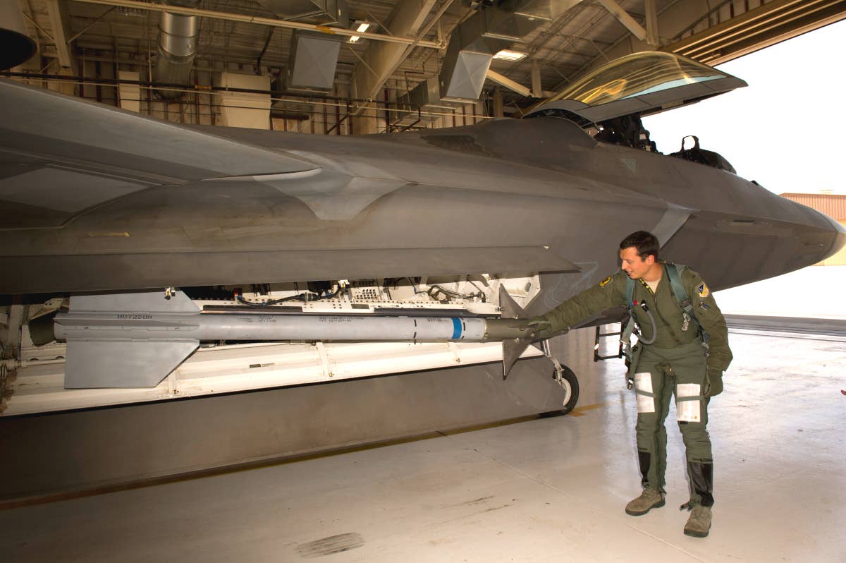 Then-U.S. Air Force 1st Lt. Andrew Van Timmeren conducts a pre-flight inspection of an F-22 in 2013. <em>USAF</em>