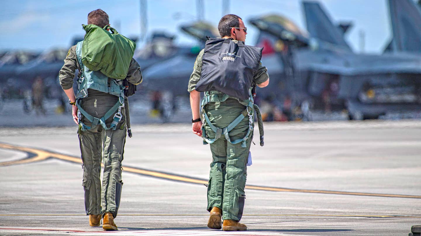 F-22 Raptor pilots walk out to the flight line for a William Tell mission. <em>Jamie Hunter</em>
