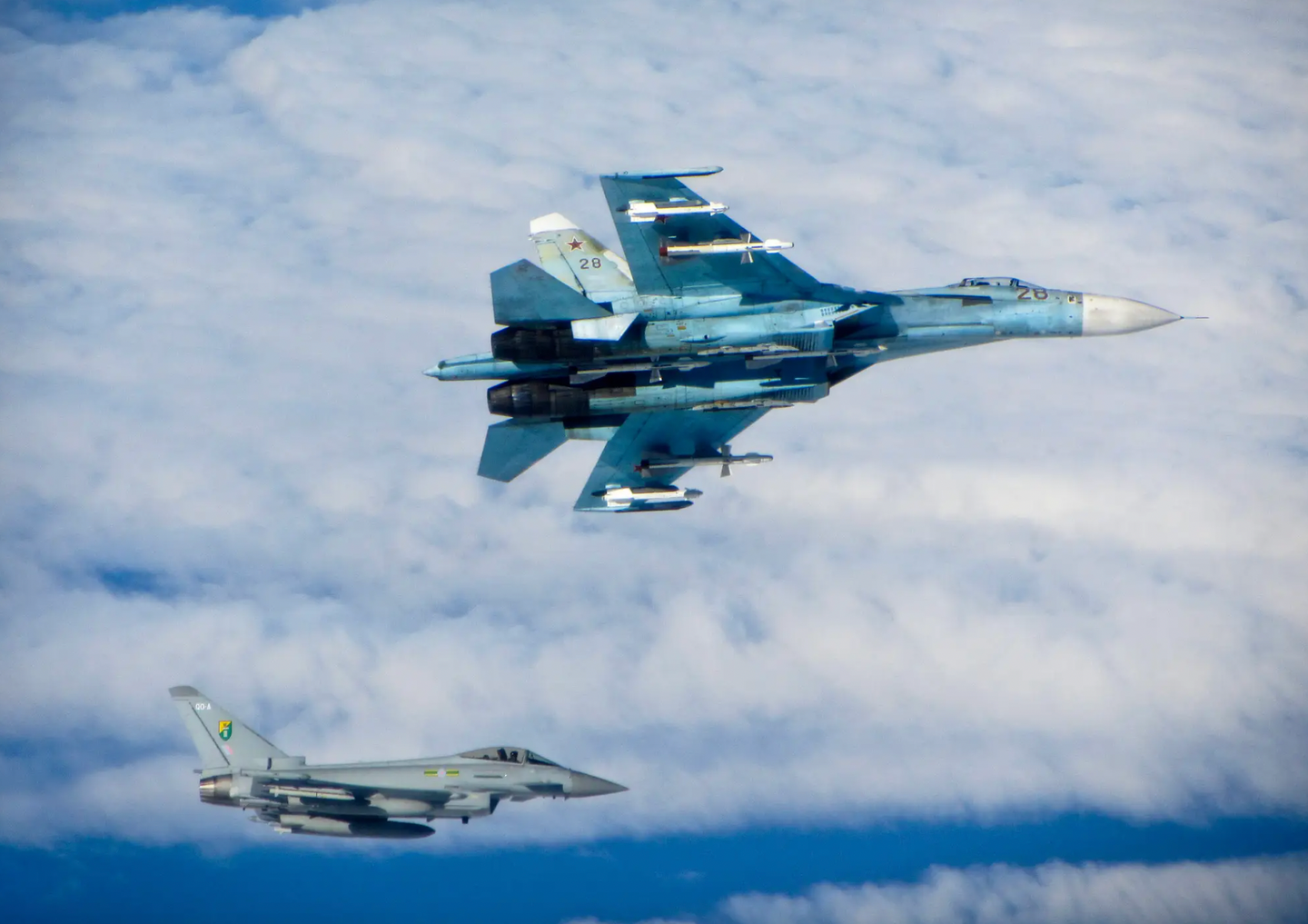 A Russian Su-27 Flanker banks away from an RAF Typhoon in international airspace over the Baltic Sea in June 2014. The Russian fighter is armed with a mix of radar- and infrared-guided R-27 and heat-seeking R-73 air-to-air missiles.&nbsp;<em>Crown Copyright</em>