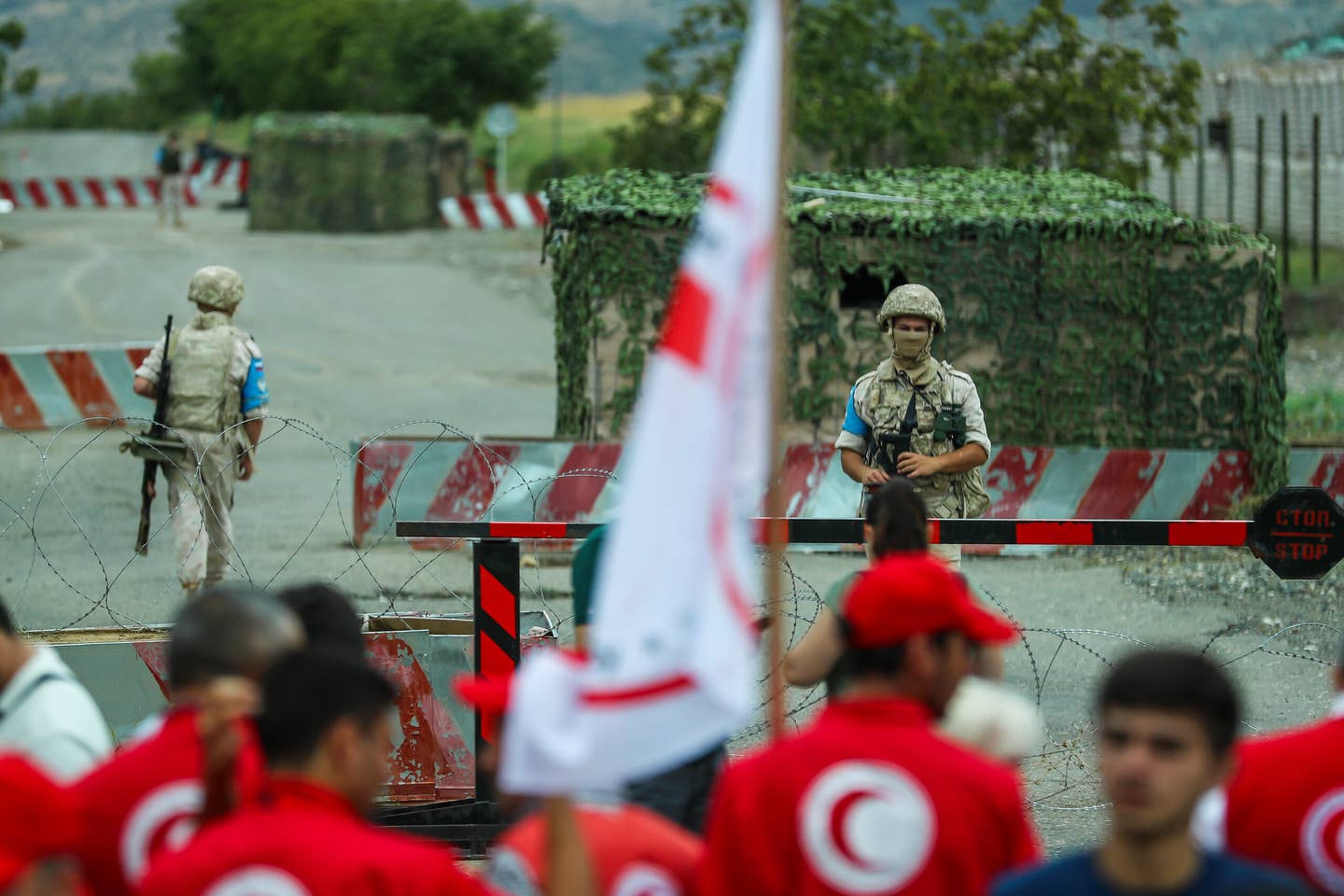 Members of the Red Crescent Society face-to-face with Russian peacekeepers at the Agdam-Khankendi border on August 30, 2023 in Aghdam, Azerbaijan. <em>Photo by Aziz Karimov/Getty Images</em>