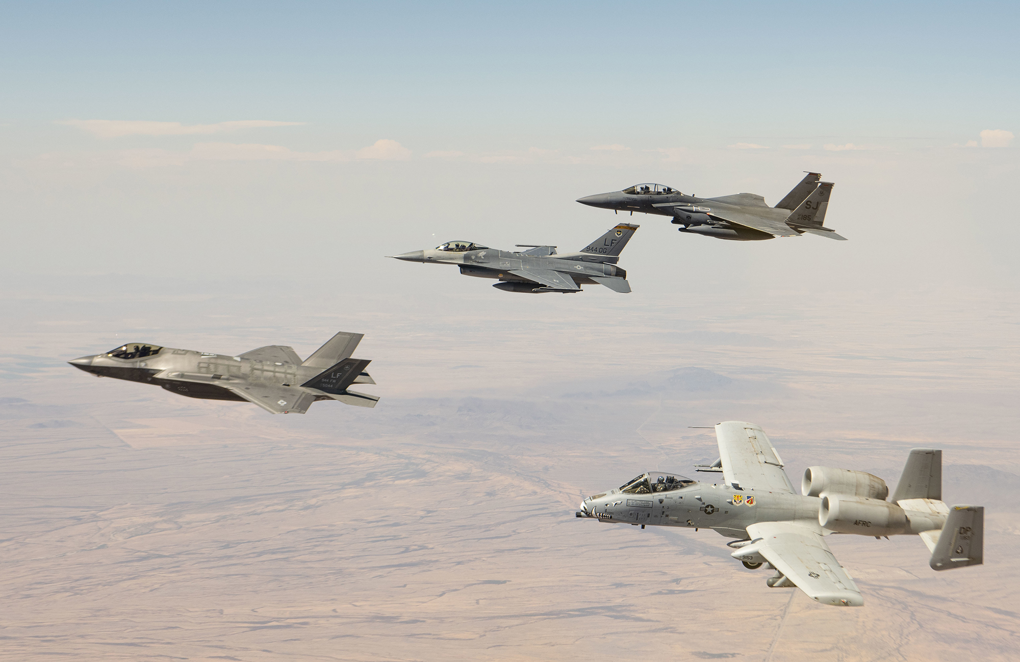 LUKE AIR FORCE BASE, Ariz.— An F-35 Lightning II, F-16 Fighting Falcon, F-15E Strike Eagle, and an A-10 Thunderbolt II fly in a four-ship formation over Arizona after being refueled by an Arizona Air National Guard KC-135 Stratotanker from the 161st Air Refueling Wing, June 3, 2021. The 944th Fighter Wing is unique in the fact that they train pilots on four different airframes, with two of them being geographically separated from the unit. The F-15E is out of Seymour Johnson Air Force Base, N.C., and the A-10 belongs to the 924th Fighter Group at Davis-Monthan Air Force Base, Ariz. The 161st ARW is stationed at Goldwater Air National Guard Base at the Phoenix Sky Harbor International Airport, Ariz.      Tech Sgt. Nestor Cruz