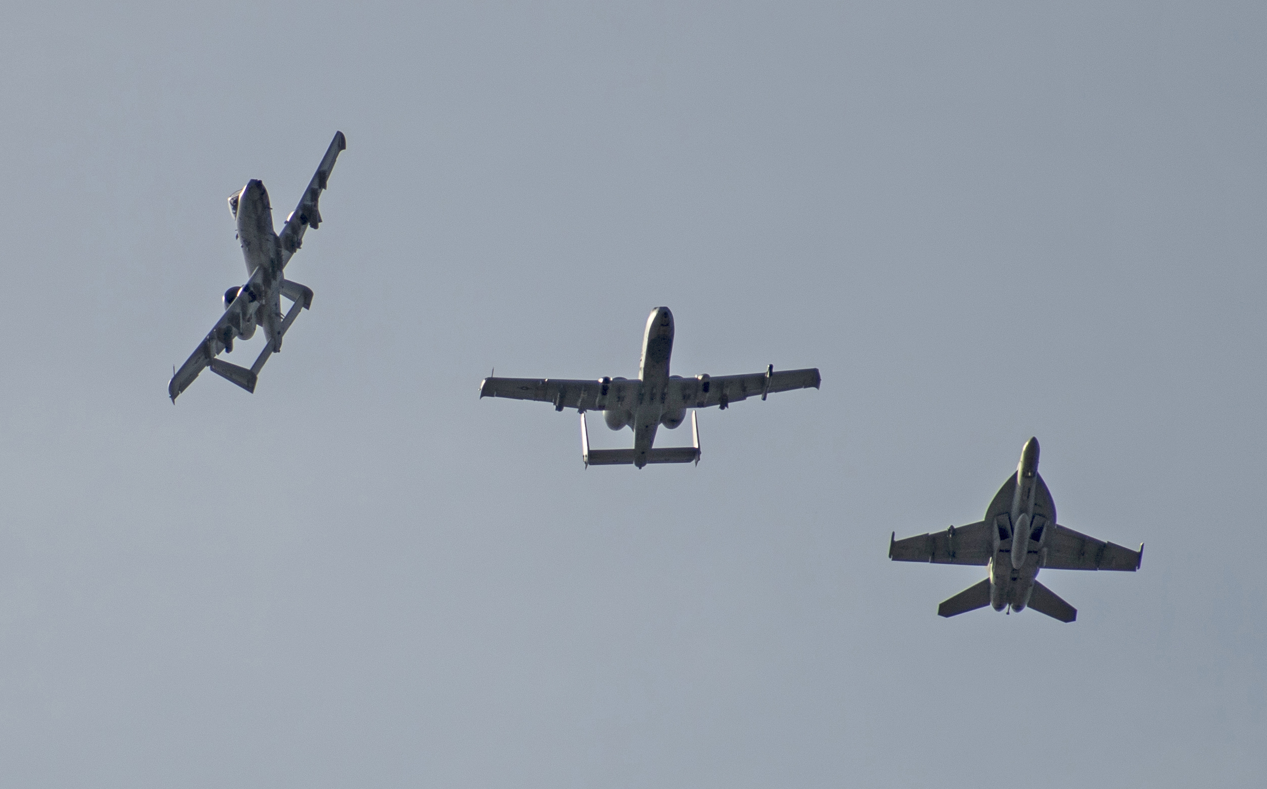 Two A-10 Thunderbolt IIs, from the 190th Fighter Squadron, Boise, Idaho, and an F-18 Super Hornet, based ashore at Naval Air Station Oceana, Virginia Beach, Virginia fly in formation after a training sortie south of Gowen Field, Boise, Idaho on April 25, 2019. The aircraft have been training hand in hand at the Mountain Home Range Complex, Idaho. (U.S. Air National Guard photo by Master Sgt. Joshua C. Allmaras)